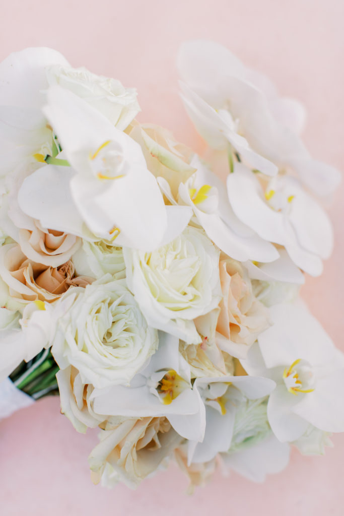 wedding bouquet with white and peach roses and orchids