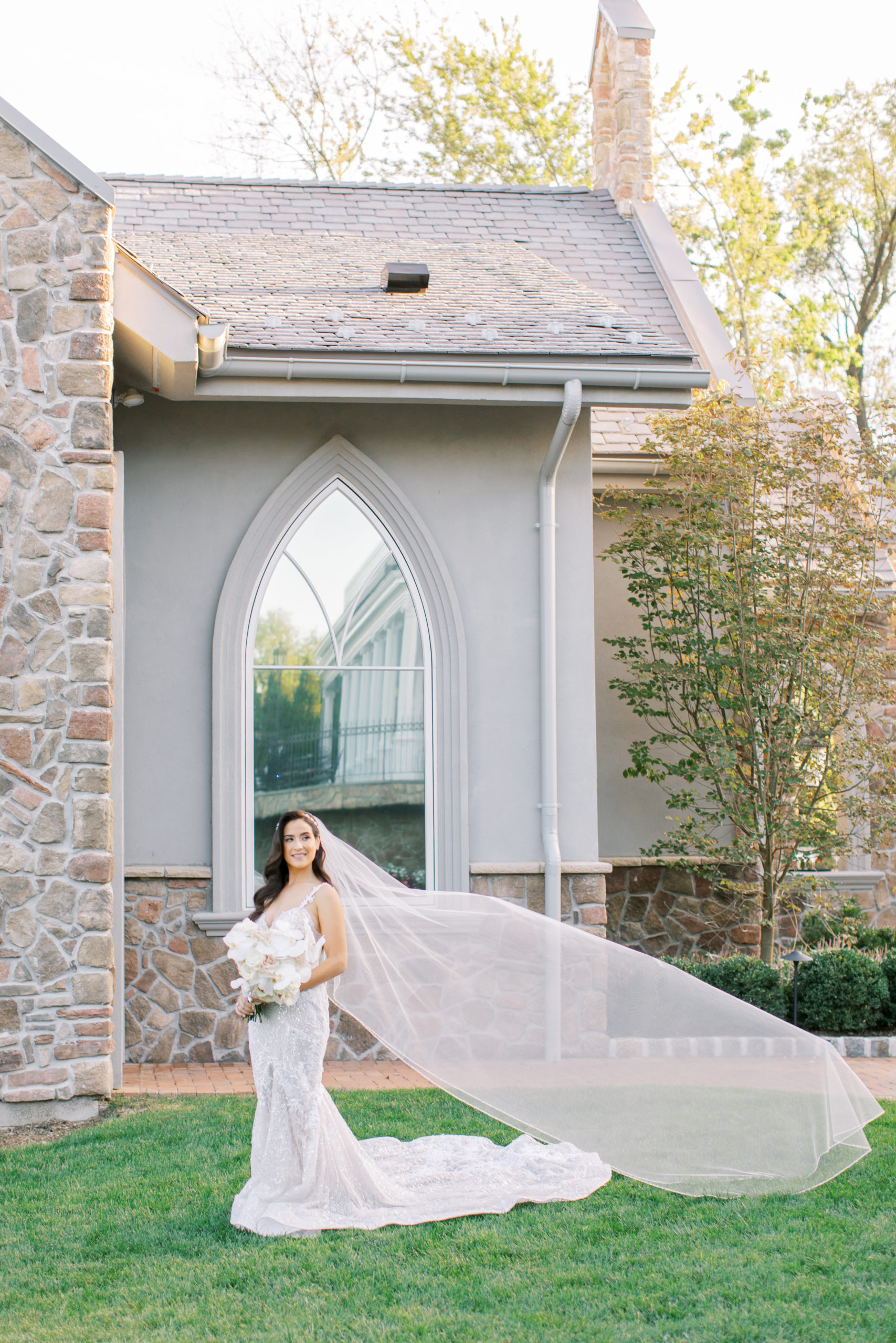 bride smiles with large arched window - Park Savoy Wedding Photography
