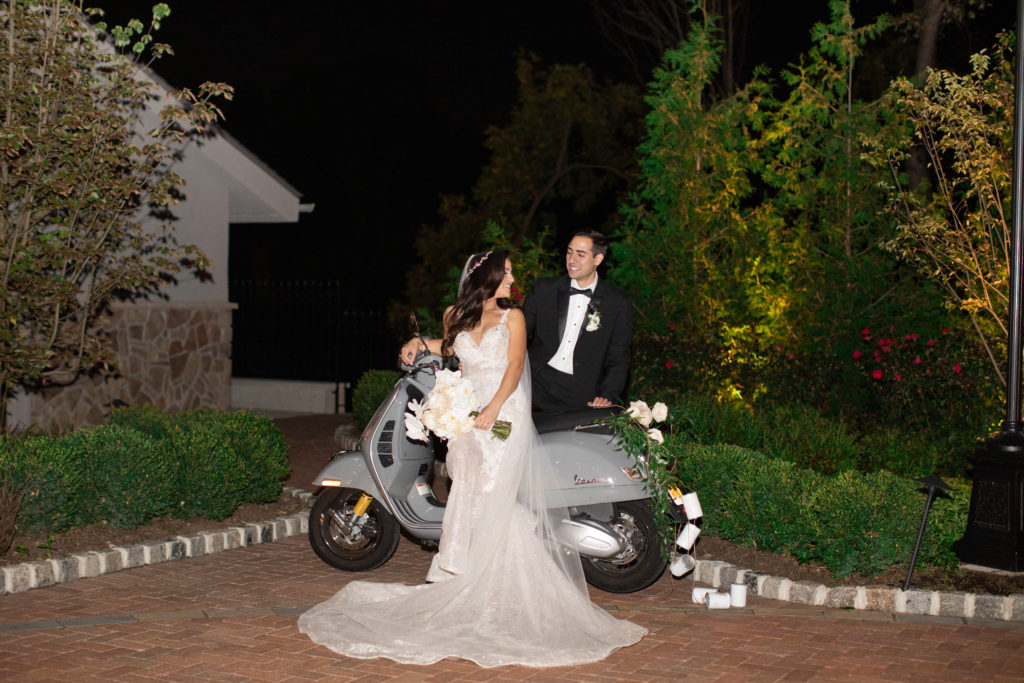 bride and groom pose with vespa after dark at park savoy