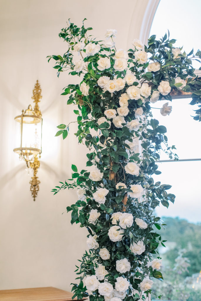 close up detail of white roses on wedding arch