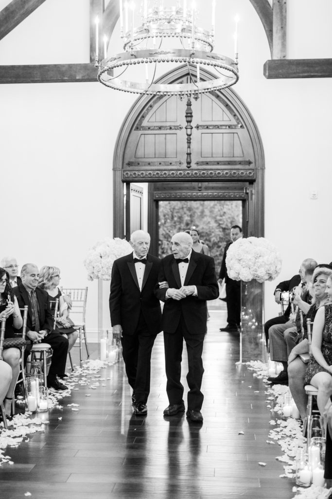 grandparents enter wedding chapel in black and white