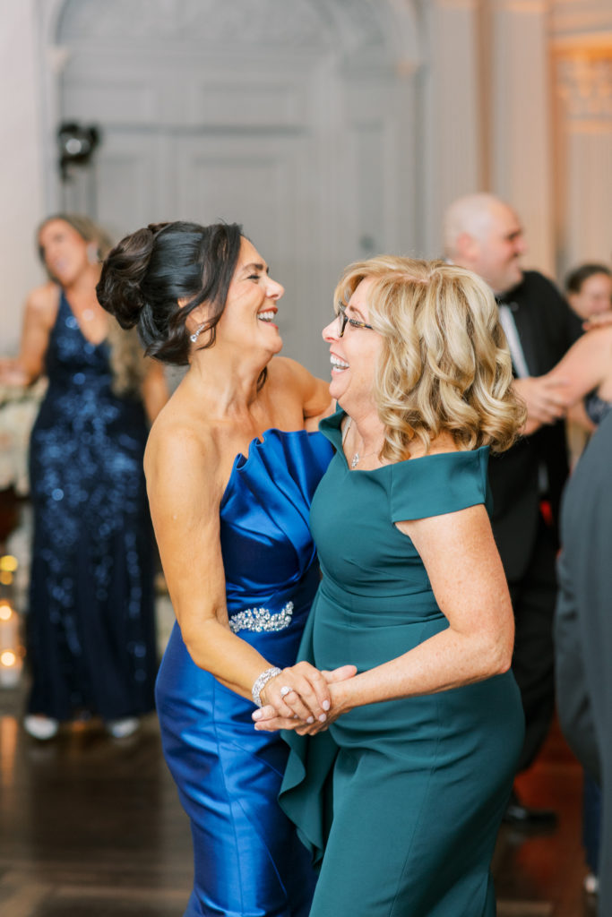 mother of the groom dances with friend