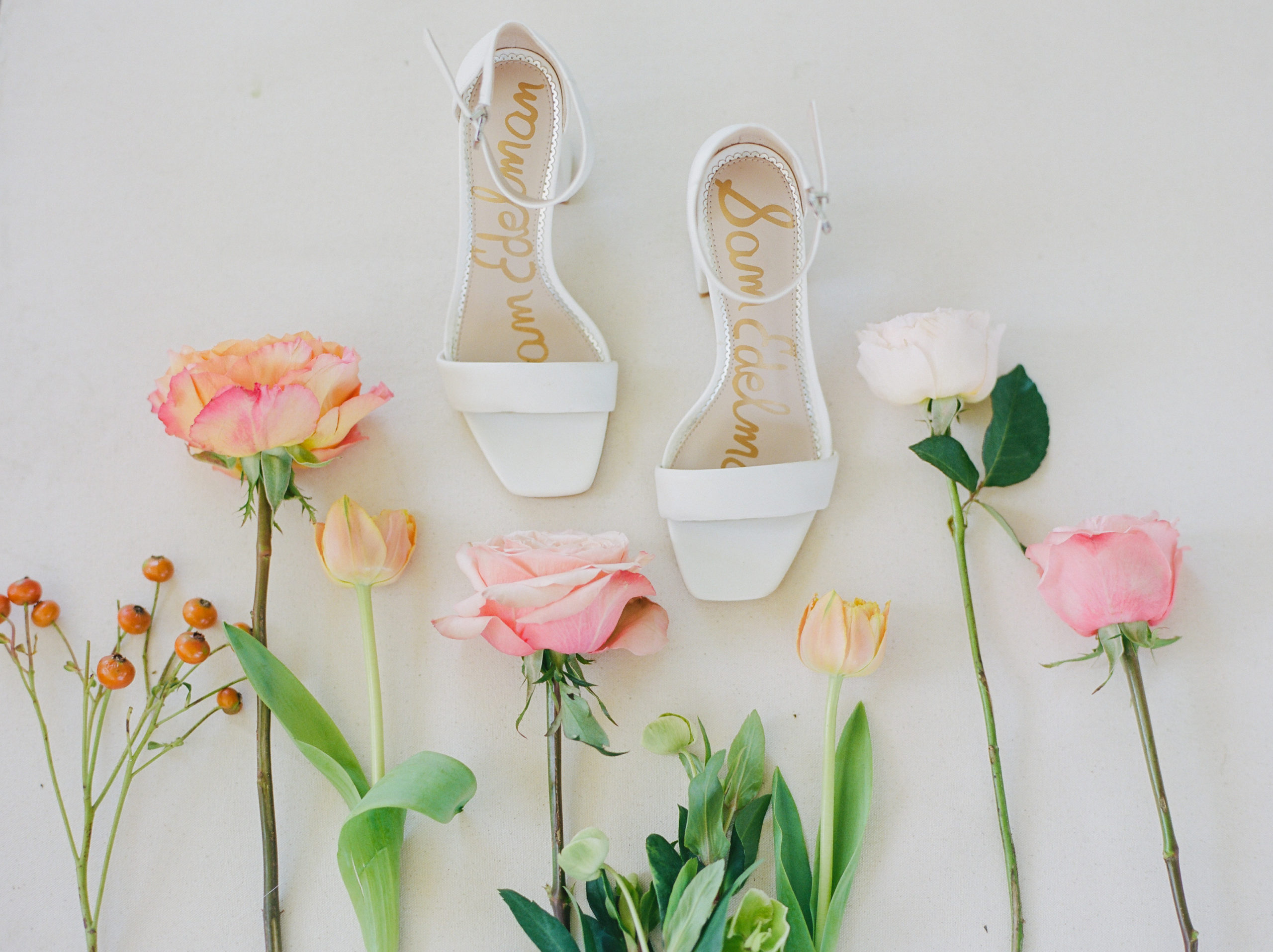 white heels with pink and gold flowers on white background NJ Private Estate Wedding Photography