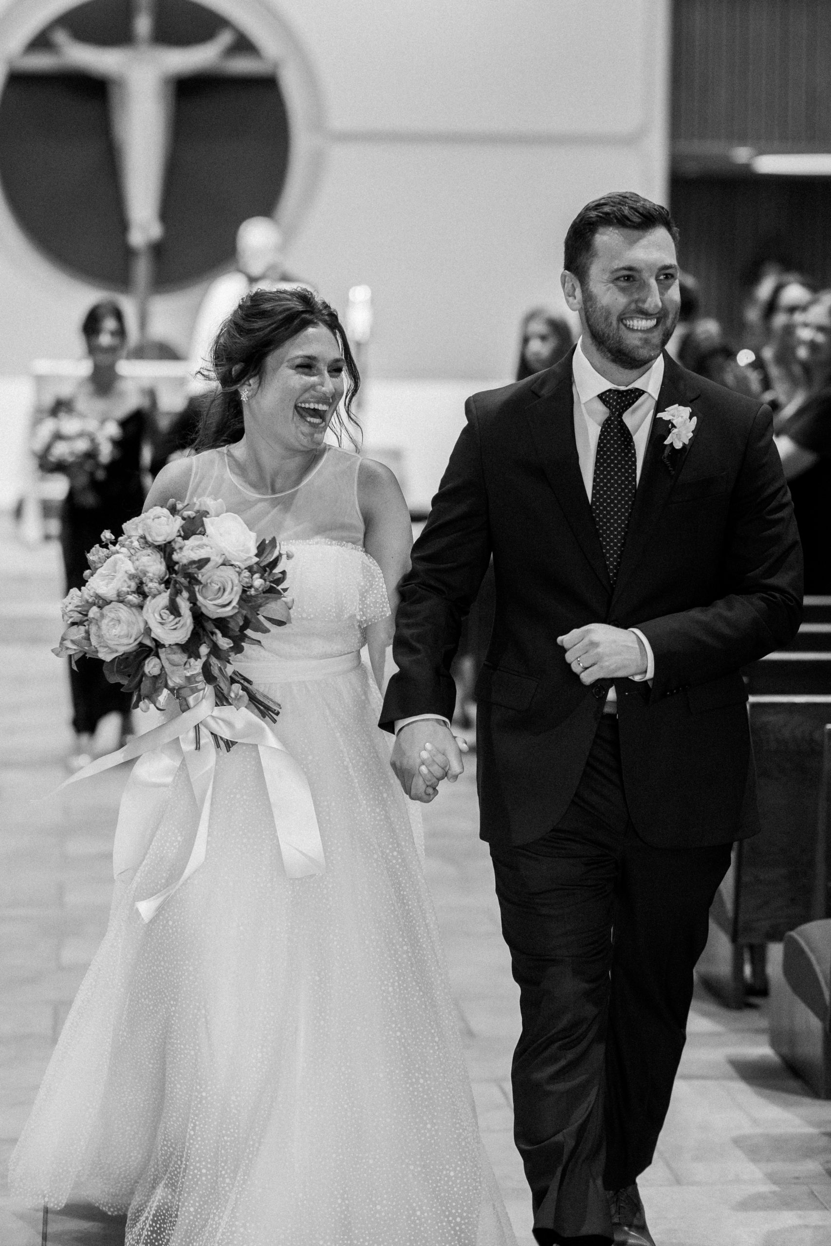 bride and groom joyfully exit church after ceremony NJ Private Estate Wedding Photography