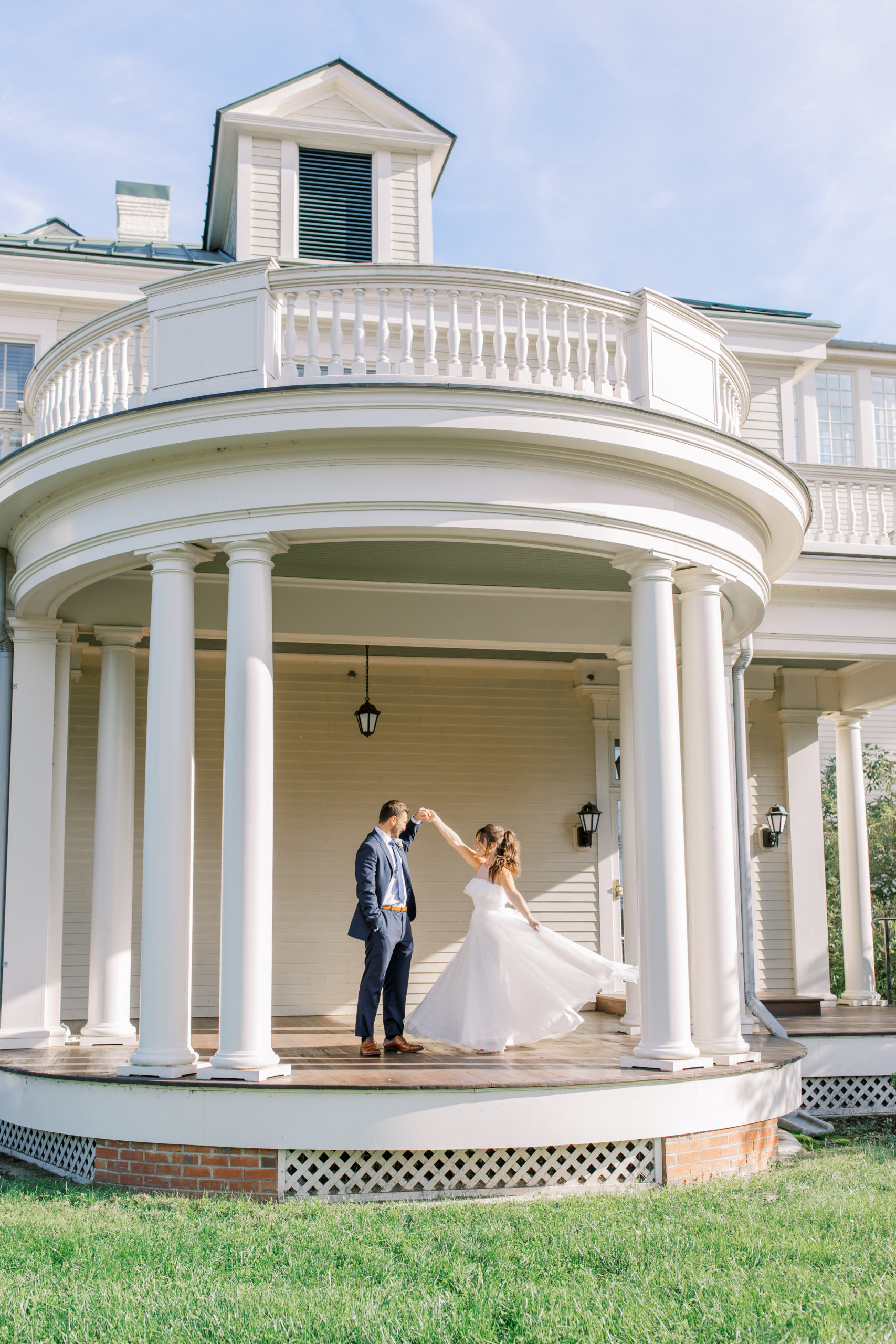 bride twirls under rotunda with groom NJ Private Estate Wedding Photography