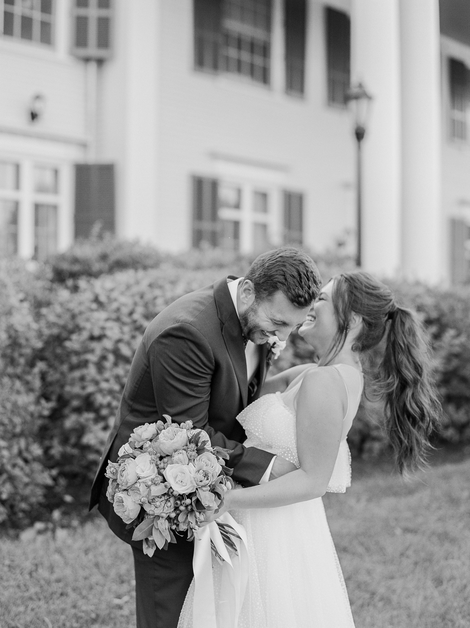 groom laughs while embracing bride in black and white NJ Private Estate Wedding Photography