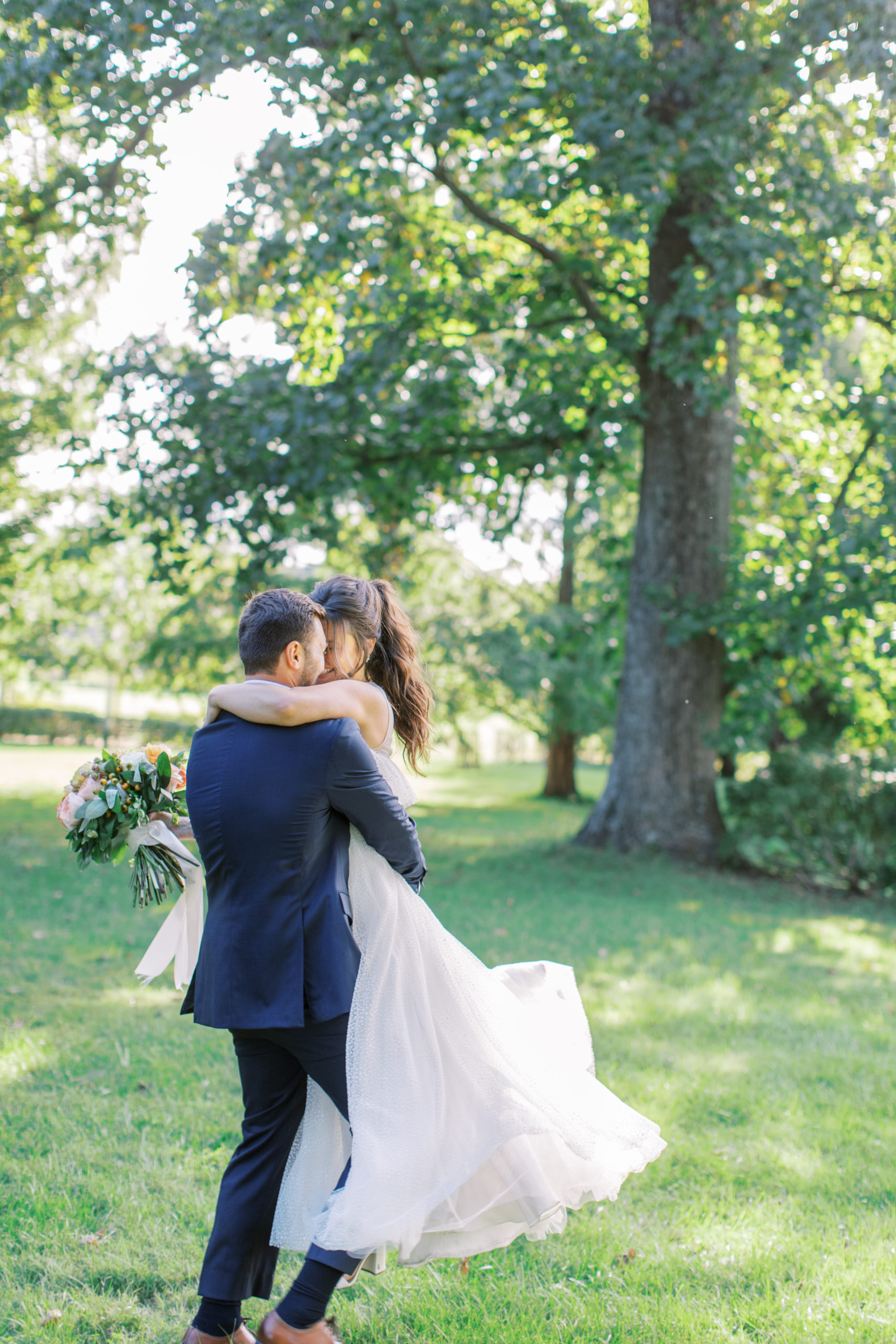 groom twirls bride in tree filled meadow NJ Private Estate Wedding Photography