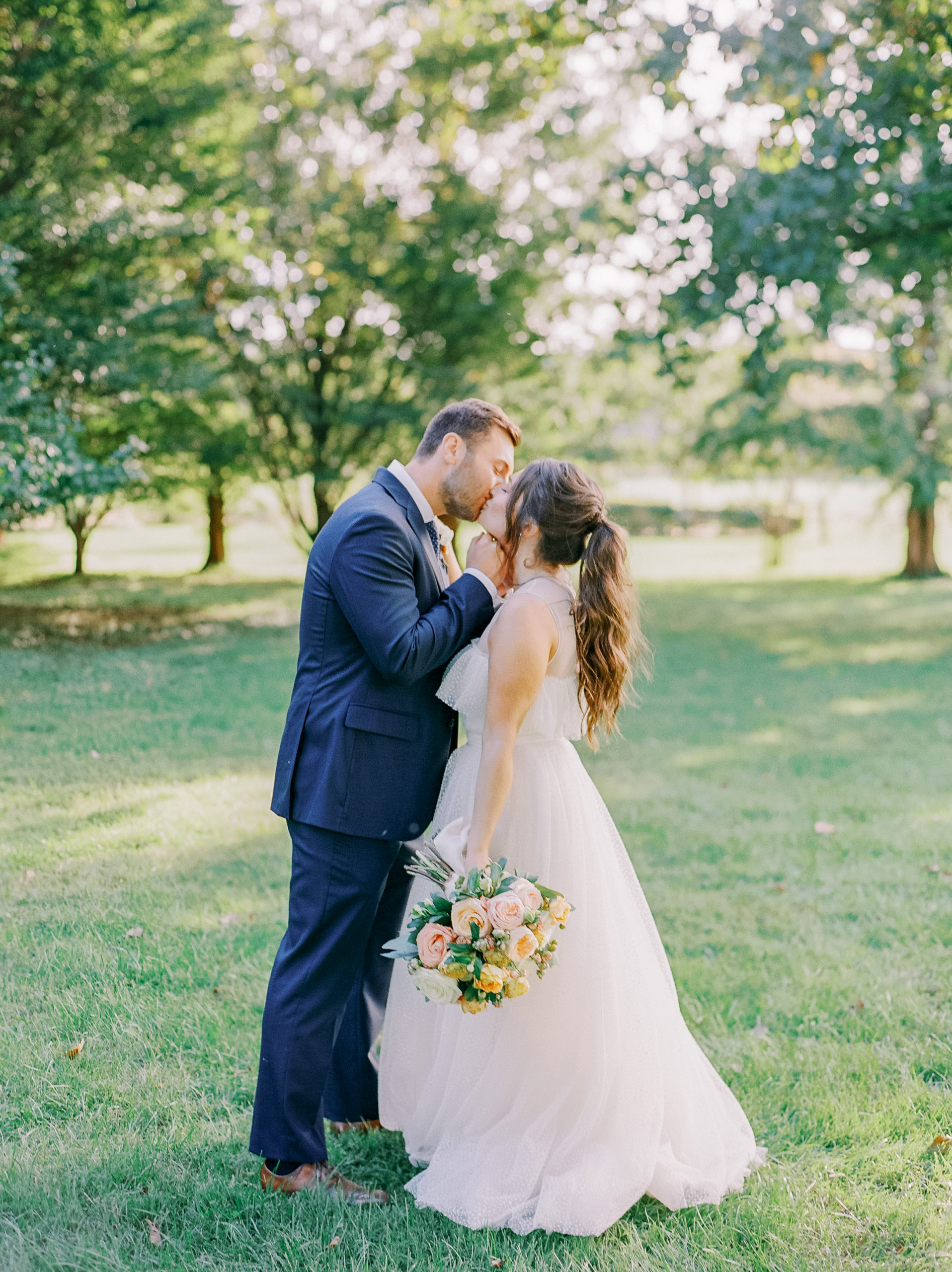 bride and groom kiss in tree lined meadow NJ Private Estate Wedding Photography