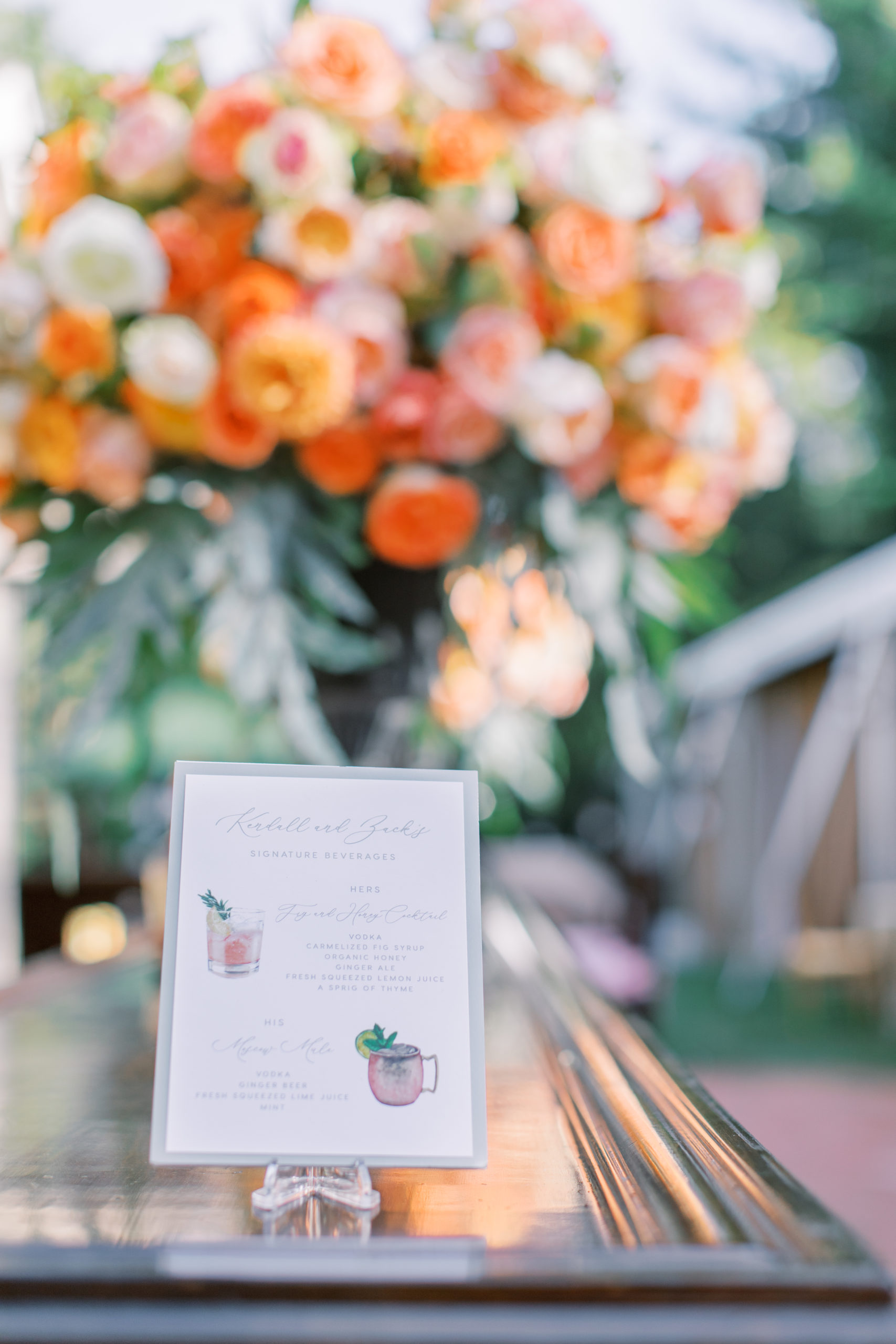 custom drink menu in front of vibrant peach and orange roses NJ Private Estate Wedding Photography