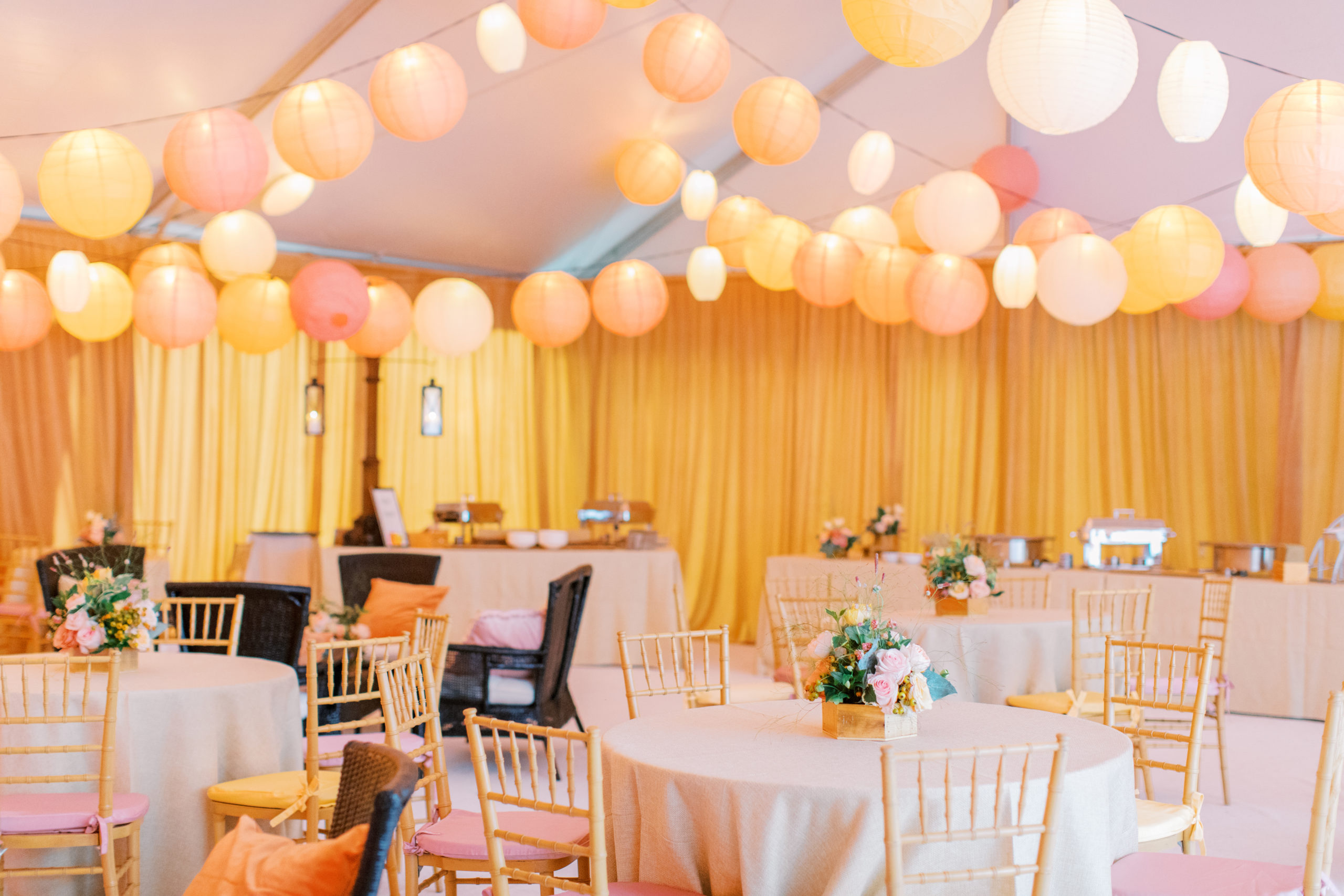 wedding reception tent with gold drapes and string lantern lights