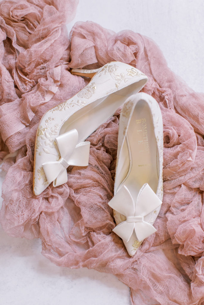 cream and gold wedding shoes with ruffled pink cloth
