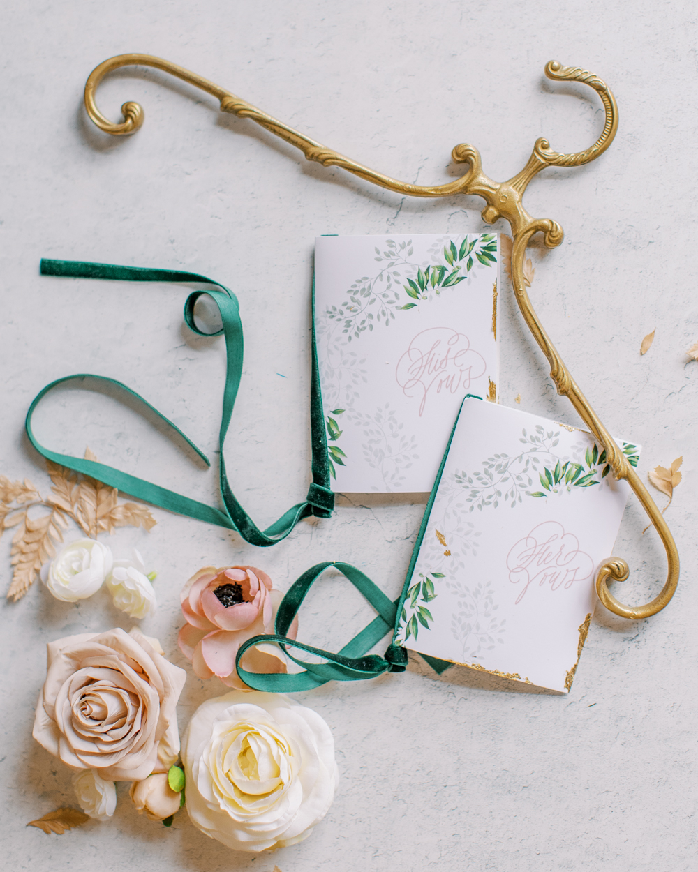 green and white vow books with gold hanger and assorted roses Bella Collina Wedding