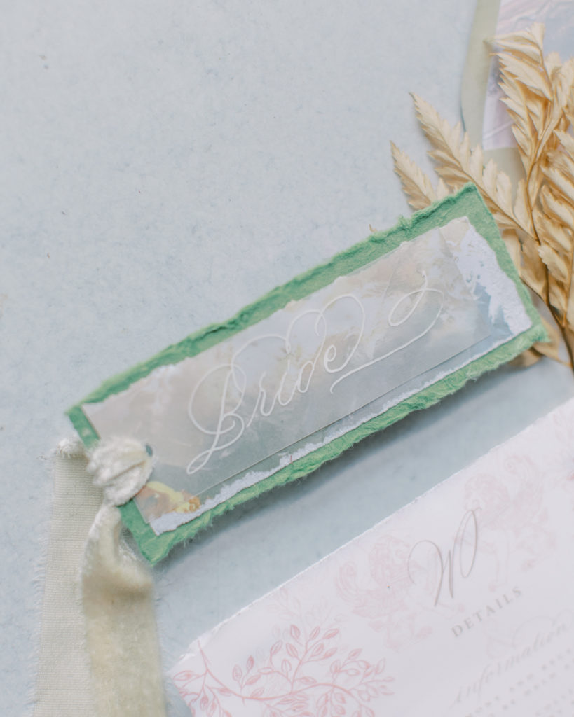 delicate calligraphed name scroll with green backing Bella Collina Wedding
