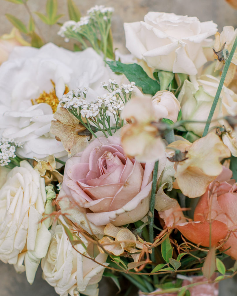 close up of bridal bouquet with shades of cream, honey, and blush