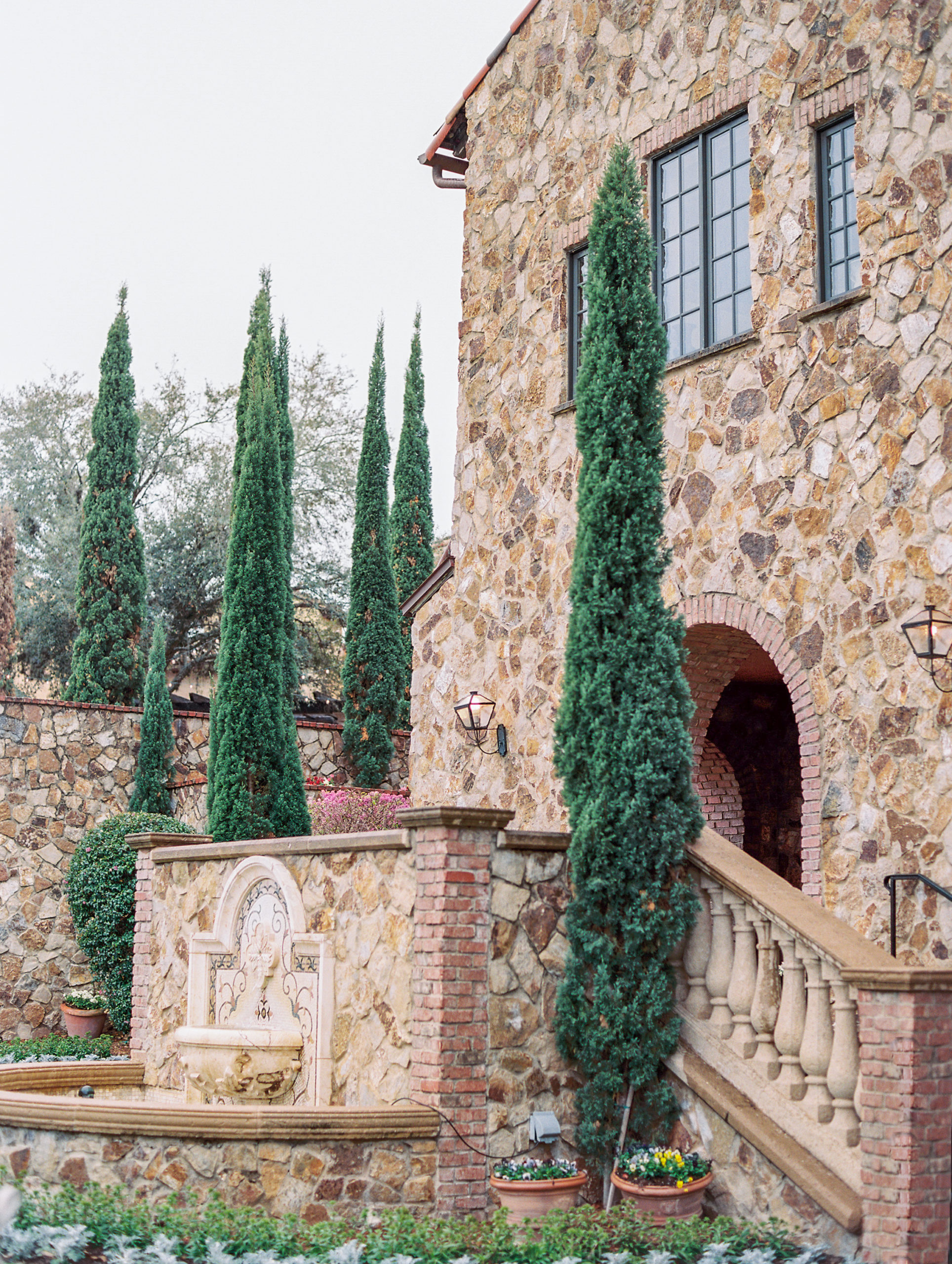 Tuscan inspired Bella Collina Wedding Photography with brick walls and tall green trees