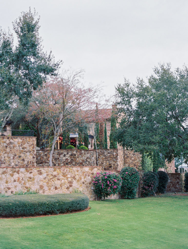 view of bella collina with string lights and flowering bushes