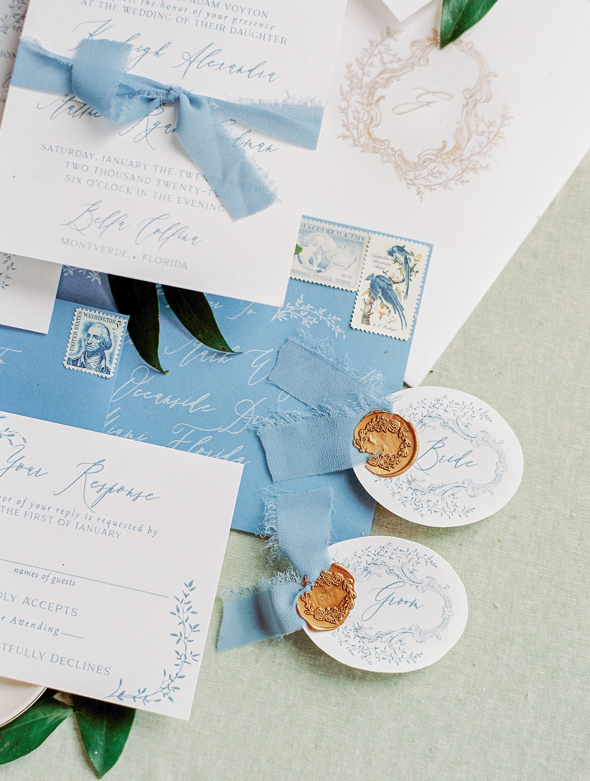 Fine Art Wedding Stationary with blue envelopes and close up detail on bride and groom tags