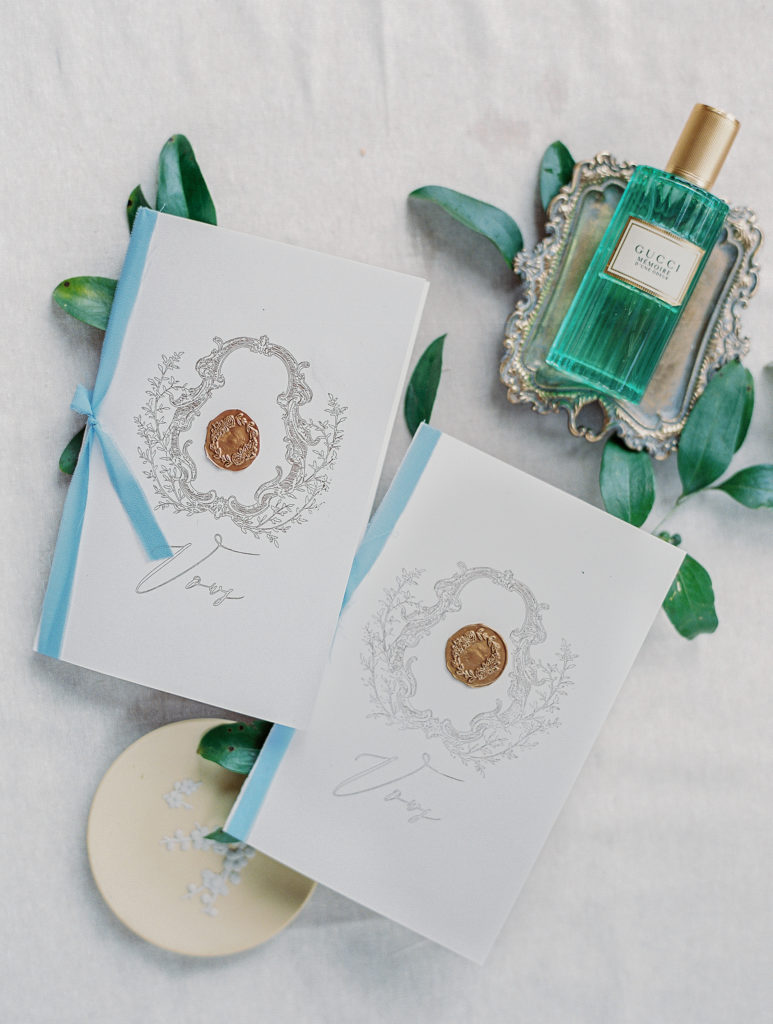 wedding vow books and green gucci perfume bottle