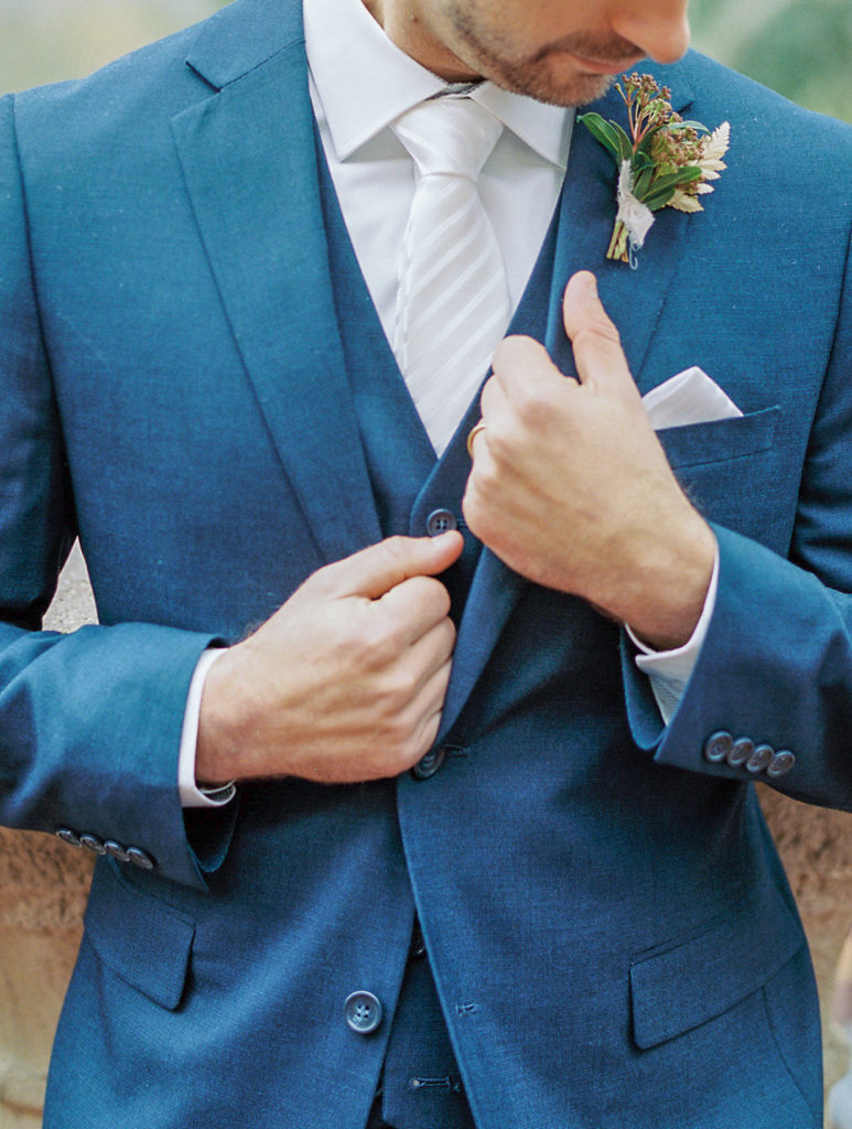 close up of groom in blue suit Bella Collina Wedding Photography