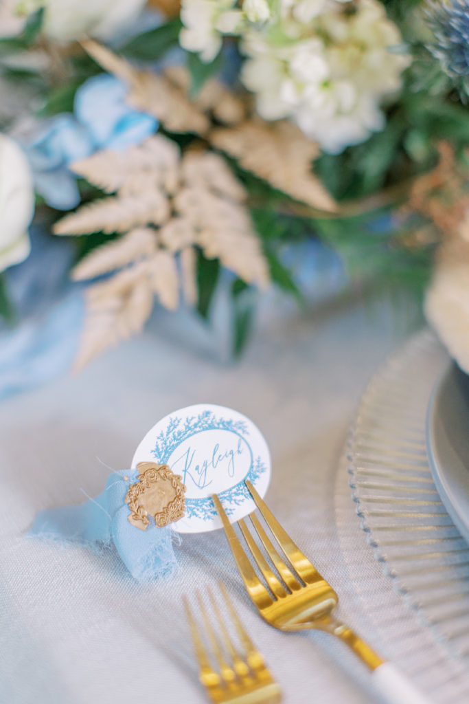 close up of reception place setting with blue and white calligraphy name cards