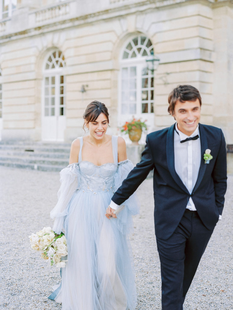 Bride and Groom joyfully walk together at Chateau de Courtomer Wedding