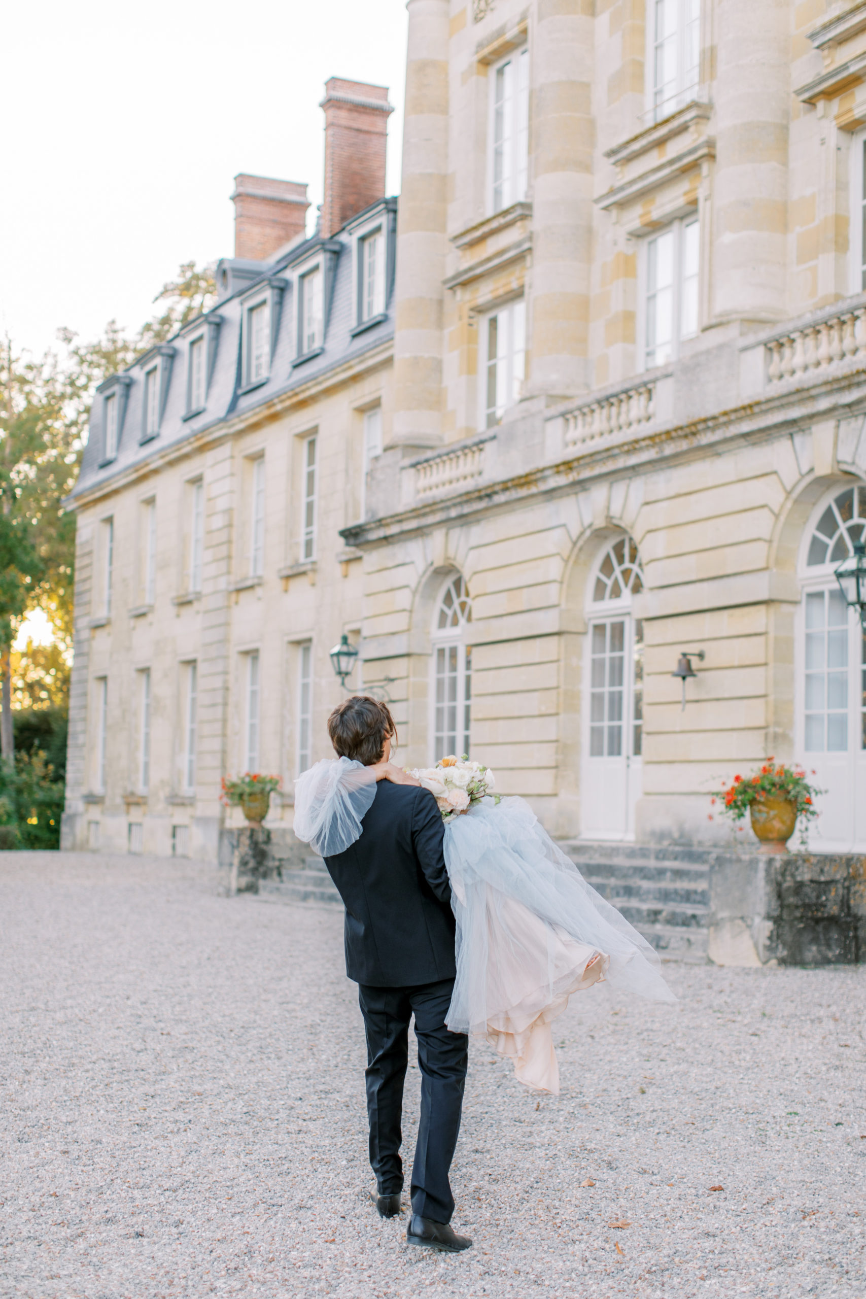 Groom carries bride after Chateau de Courtomer Wedding ceremony