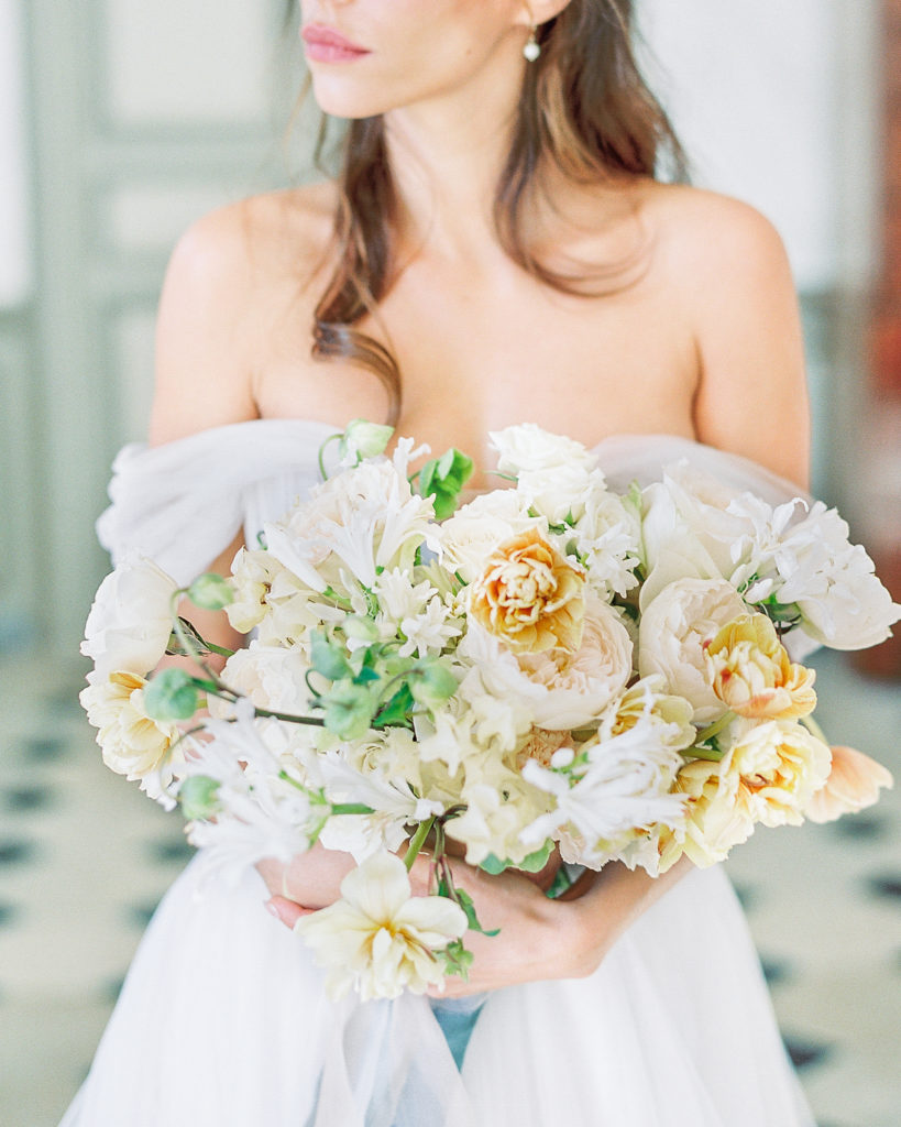 Bride holding bouquet at french chateau wedding