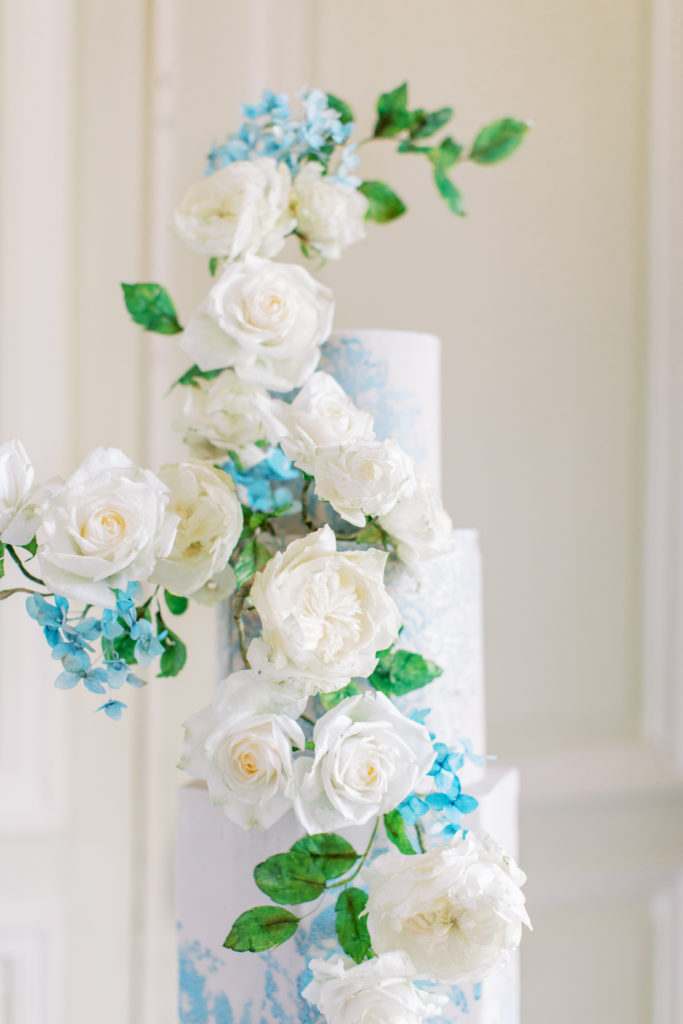 flowers adorn hand painted wedding cake at Chateau de Courtomer Wedding