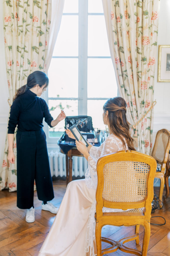Bride gets hair and makeup done at french chateau wedding