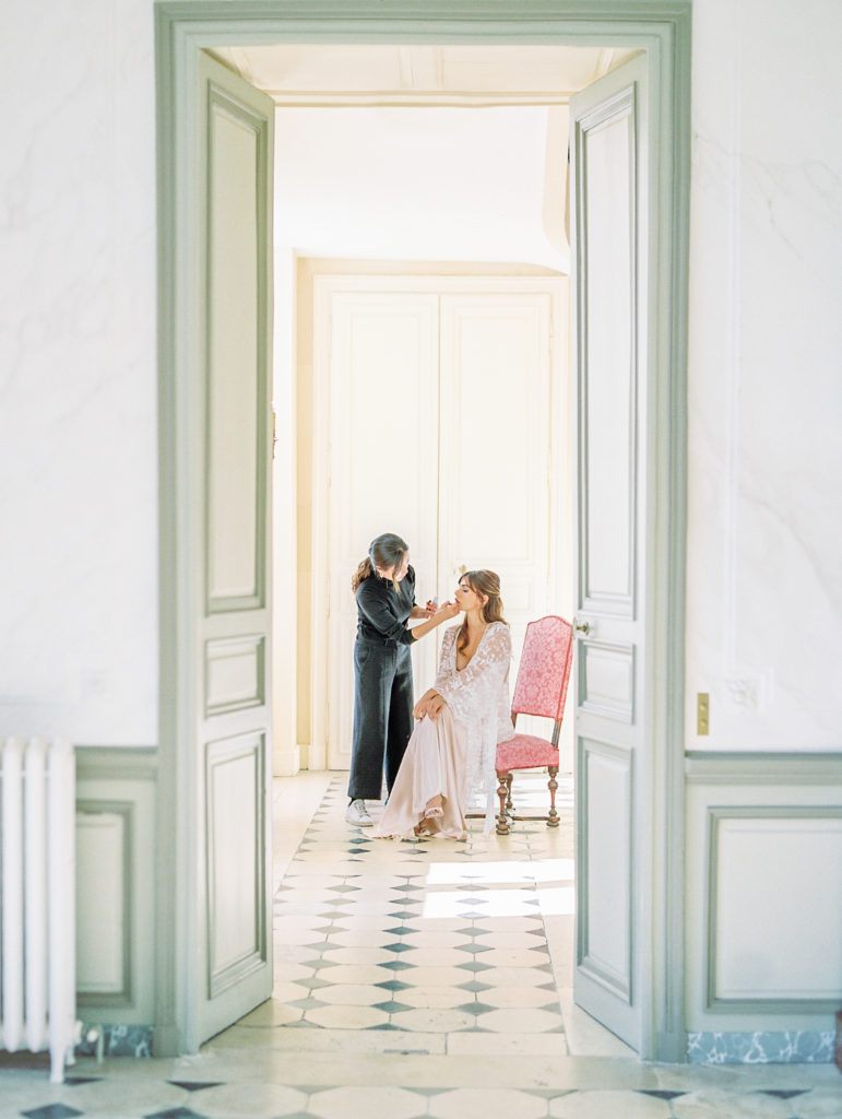 Bride gets makeup done at french chateau wedding