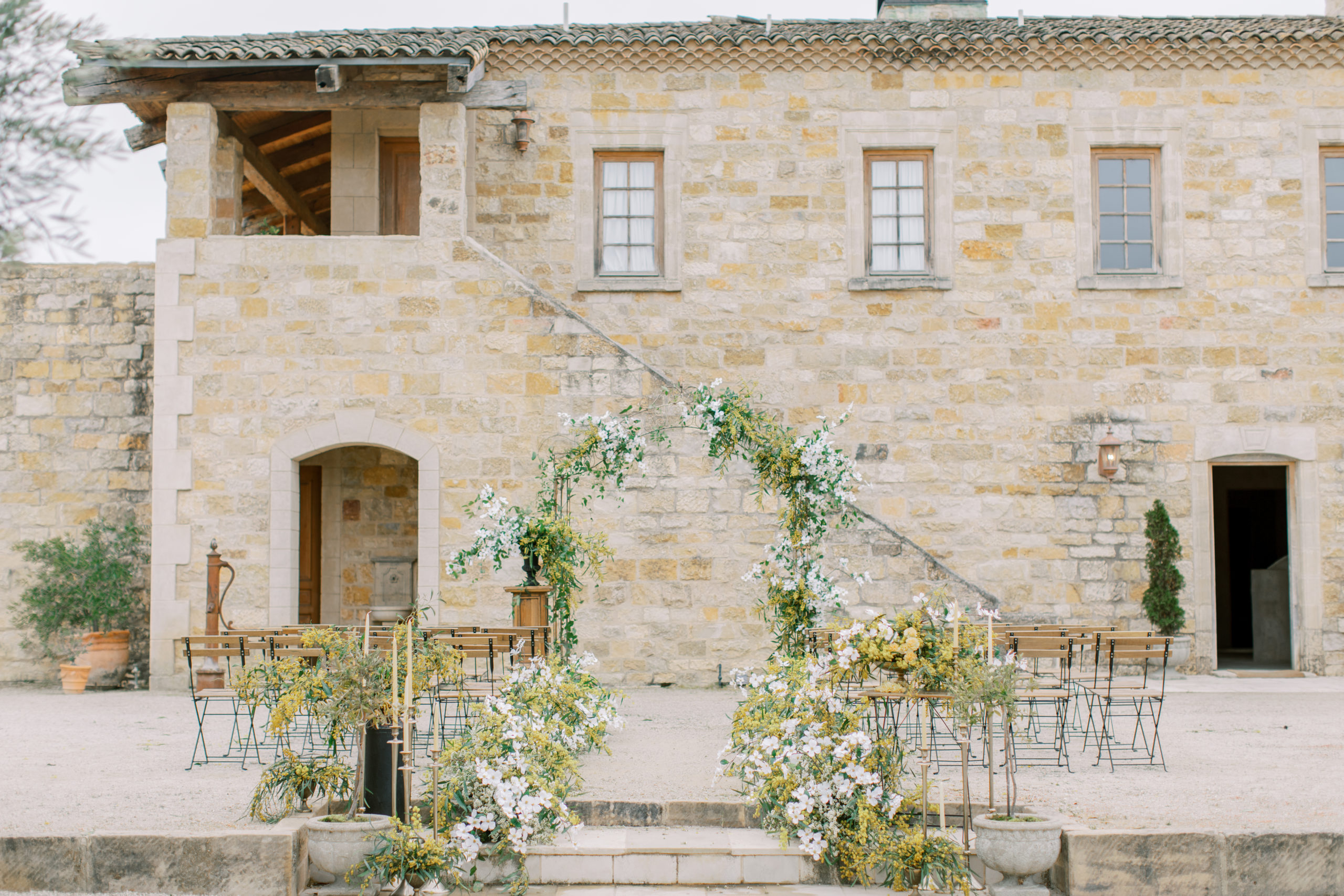 Italian villa ceremony with gold and white flowers Sunstone Winery Wedding Photography