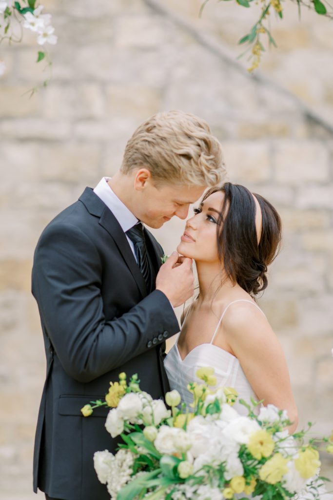 groom brings bide close for a kiss at california wedding Sunstone Winery Wedding Photography
