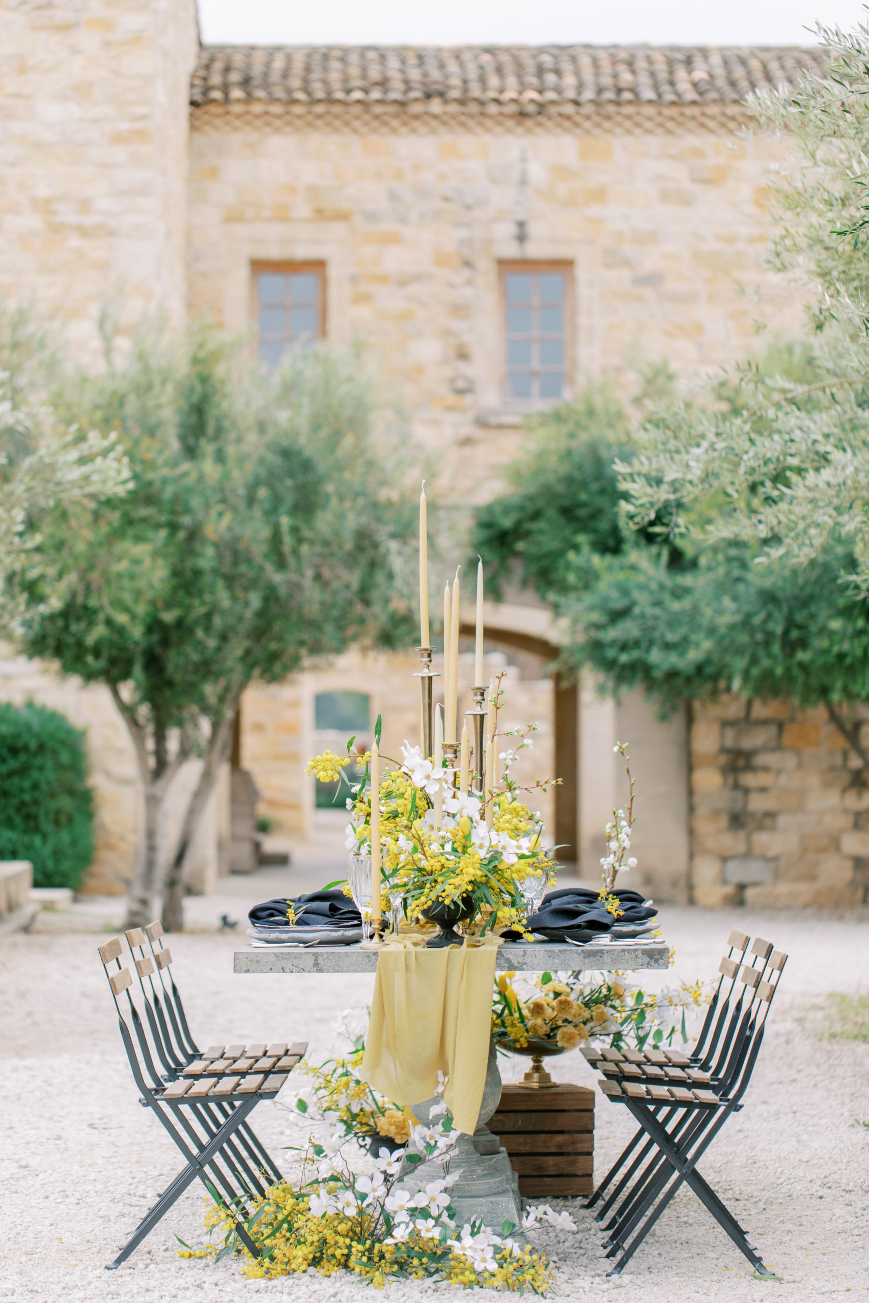 wedding reception table at italian villa wedding with honey colored flowers and olive trees Sunstone Winery Wedding Photography
