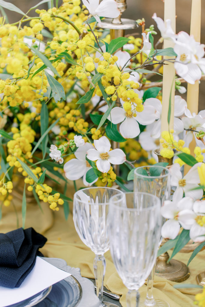 close up of gold and white flowers on reception table