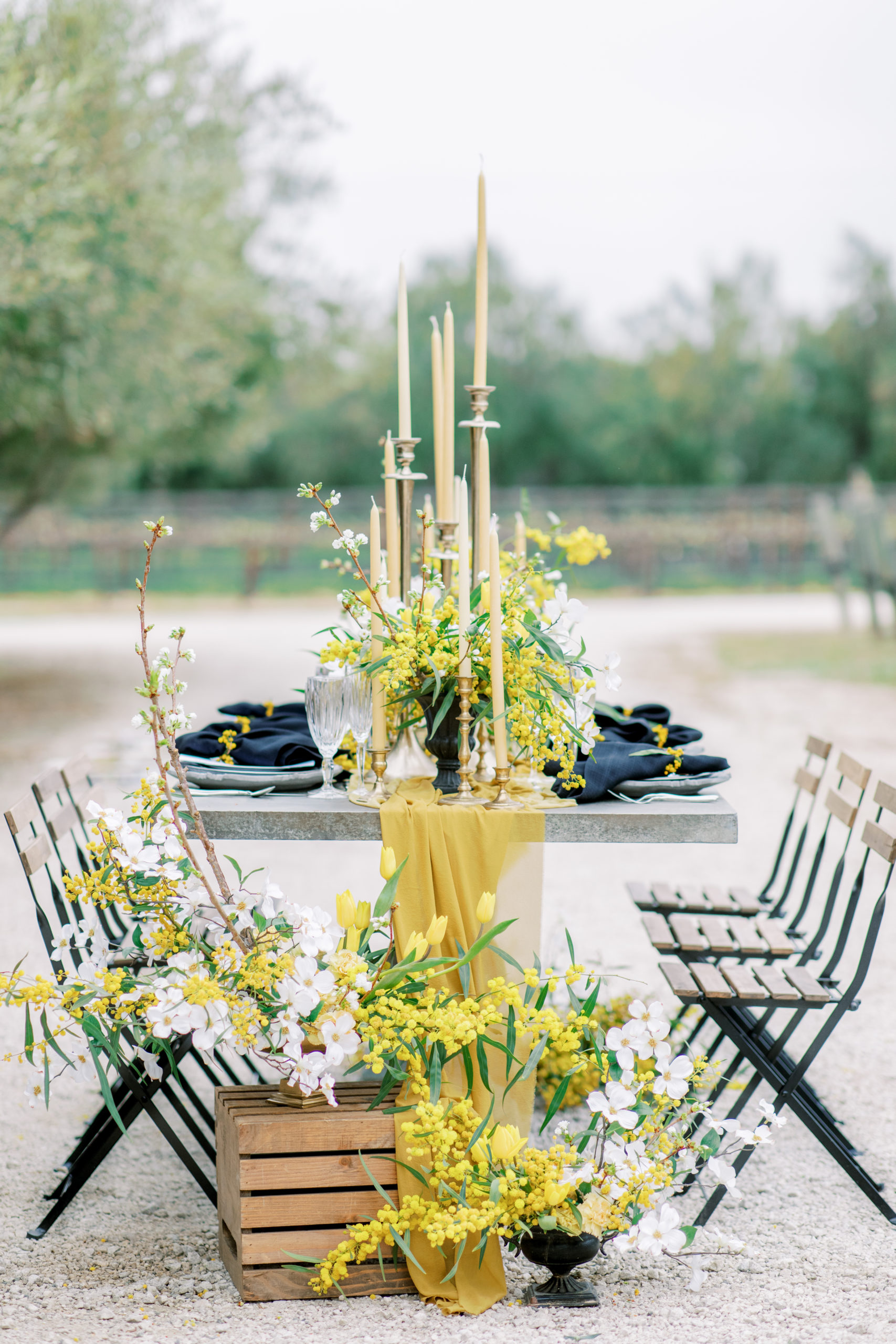 wedding reception table with gold flowers and tall honey candlesticks Sunstone Winery Wedding Photography