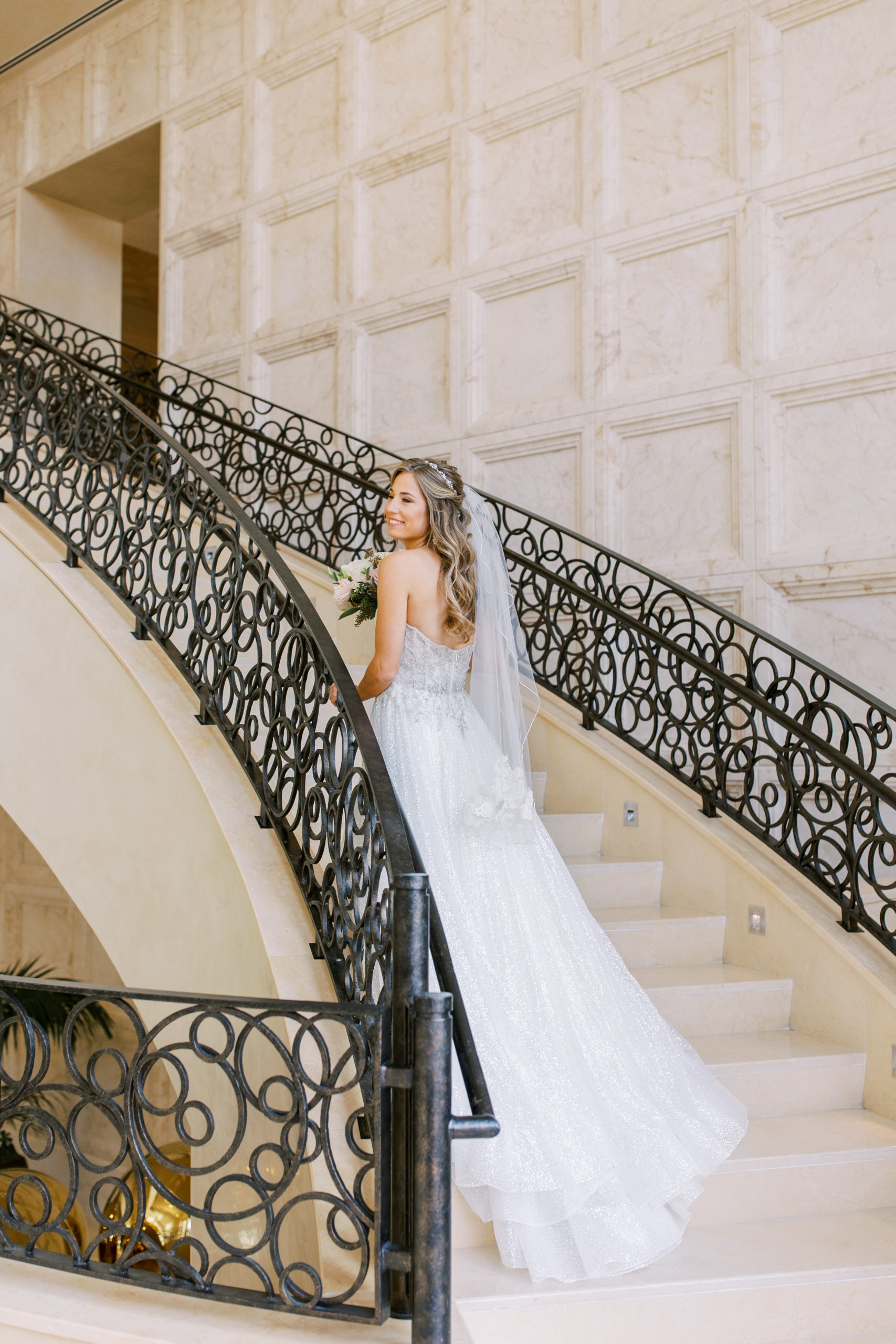 Bride smiles on the steps of the Four Seasons Walt Disney World Wedding Photography