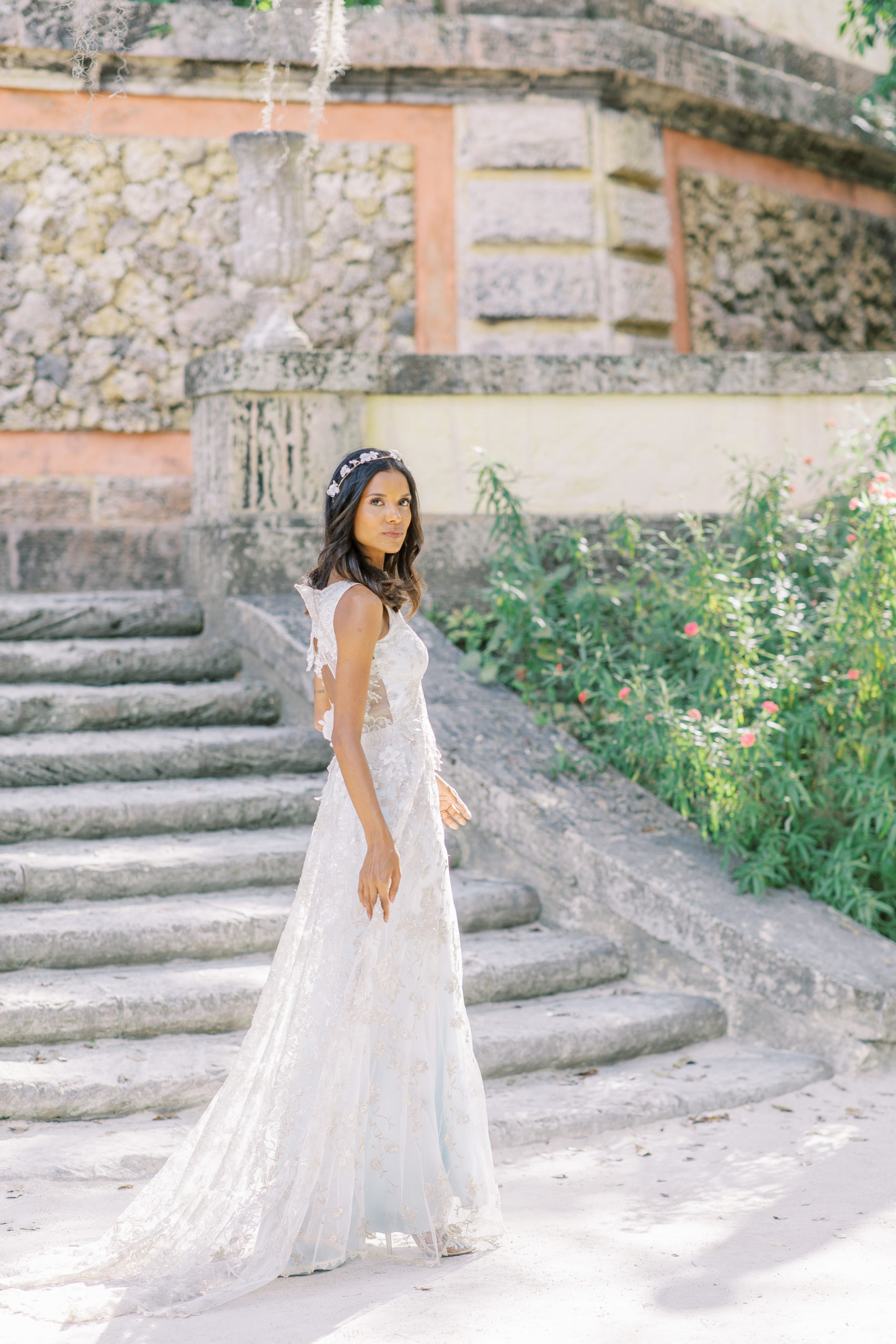 bride in front of stone. steps at vizcaya museum