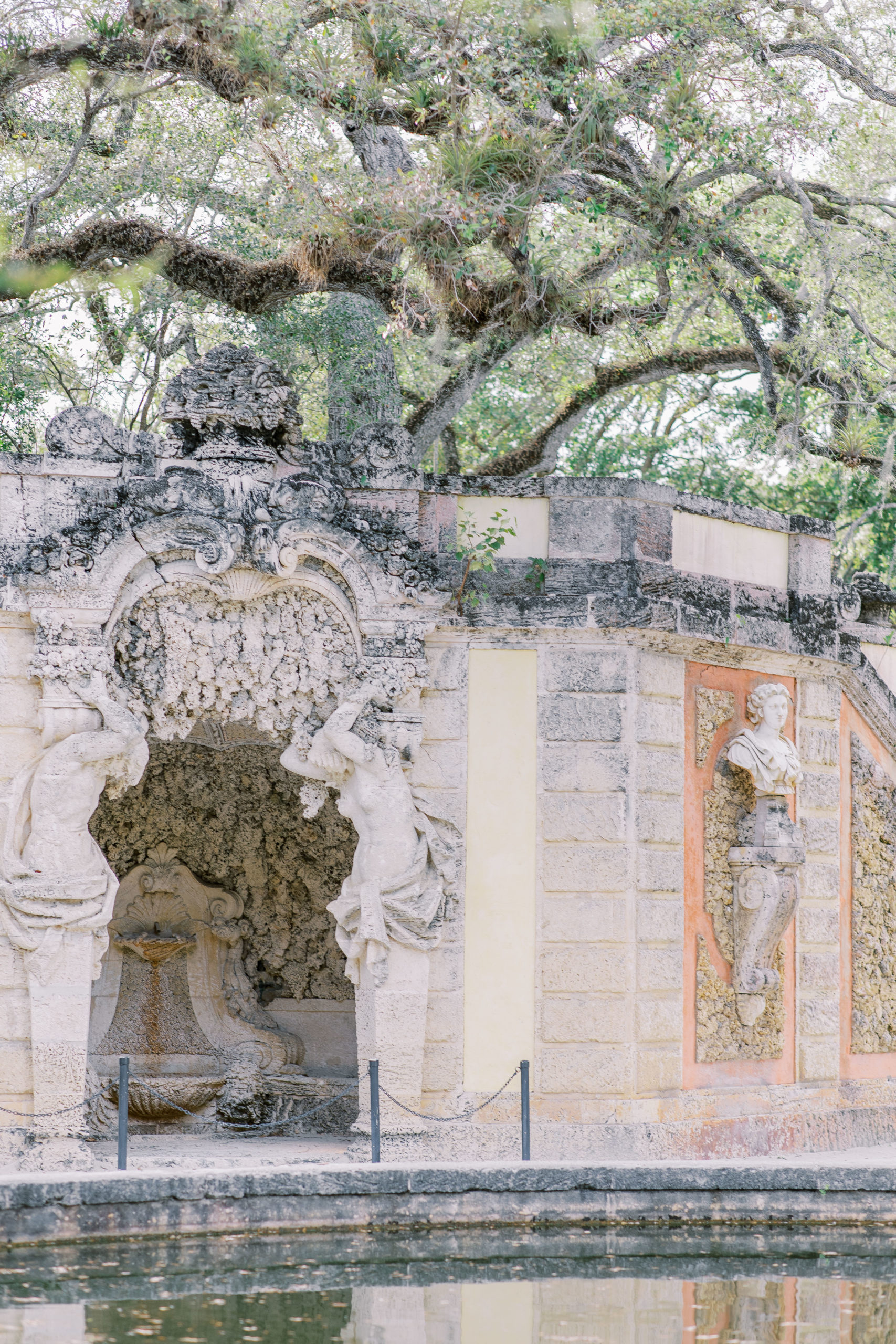 Reflecting pool with intricate stonework and spanish moss trees