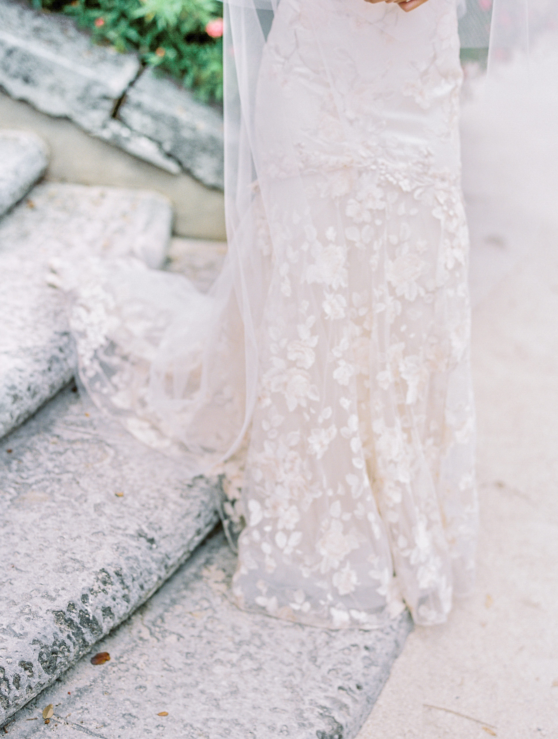 detail of claire pettibone dress on stone steps