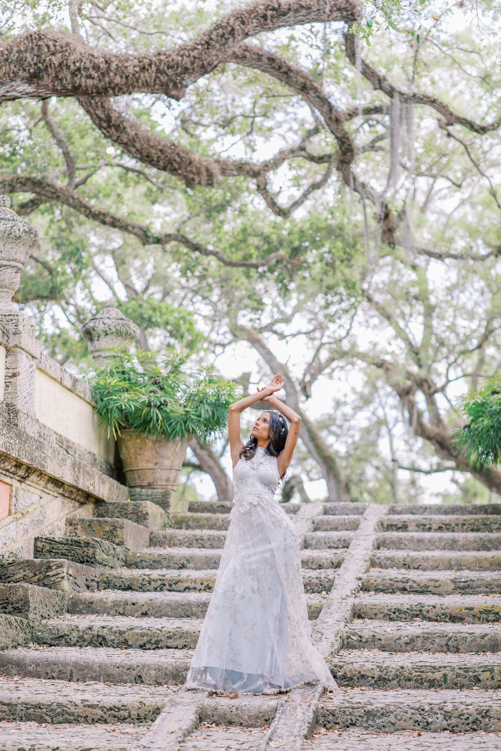 bride in blue and cream claire pettibone dress on stone steps