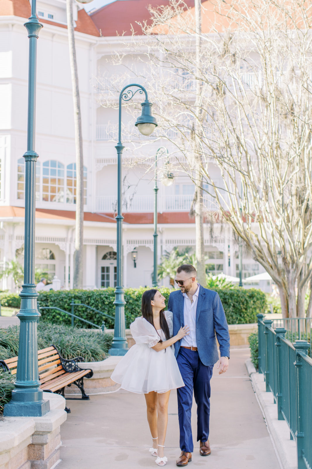 Disney Grand Floridian Engagement Session with groom in blue suit and bride in stylish selkie dress