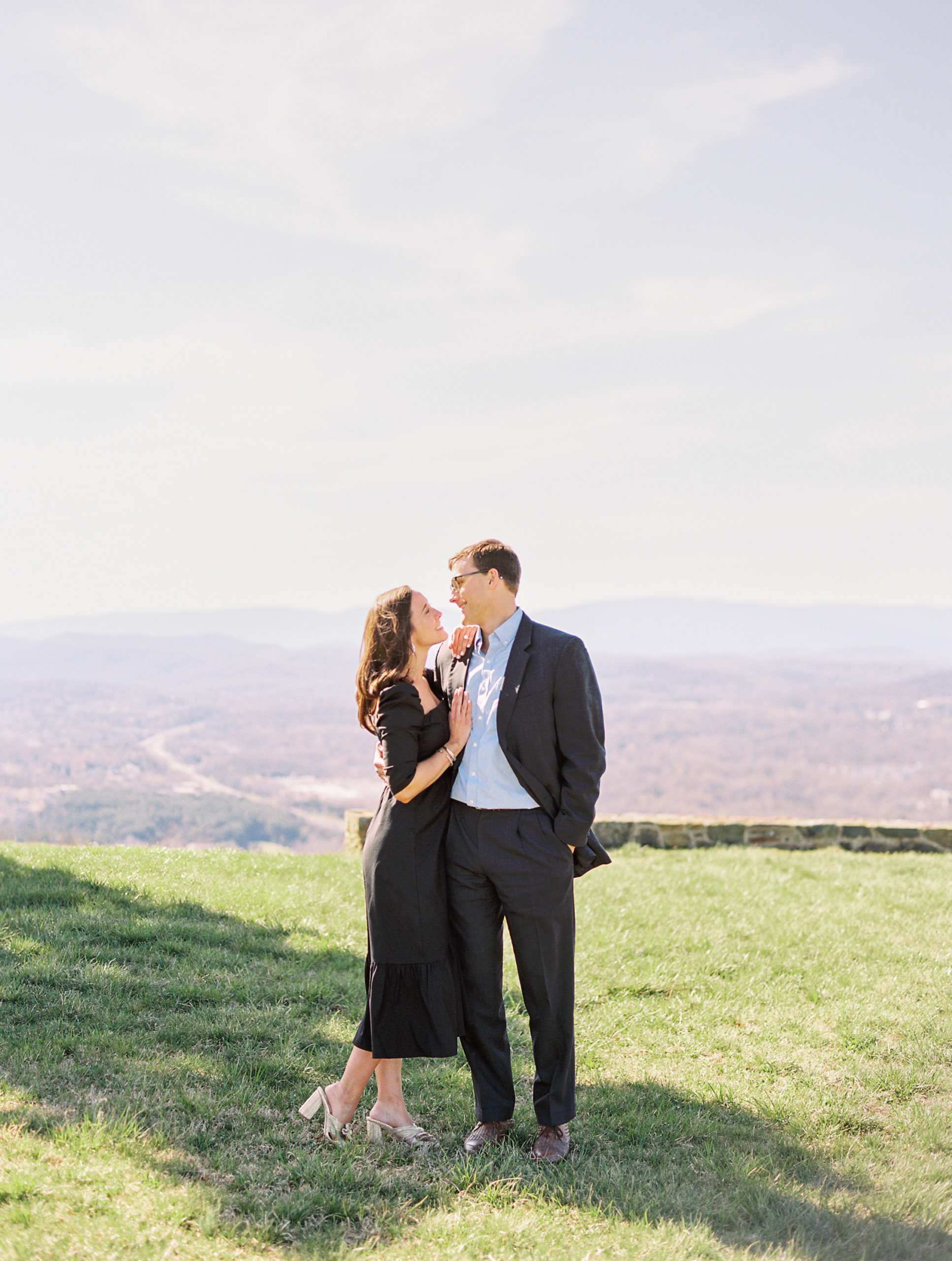 couple smiles at one another at Spring at Montalto Engagement Session