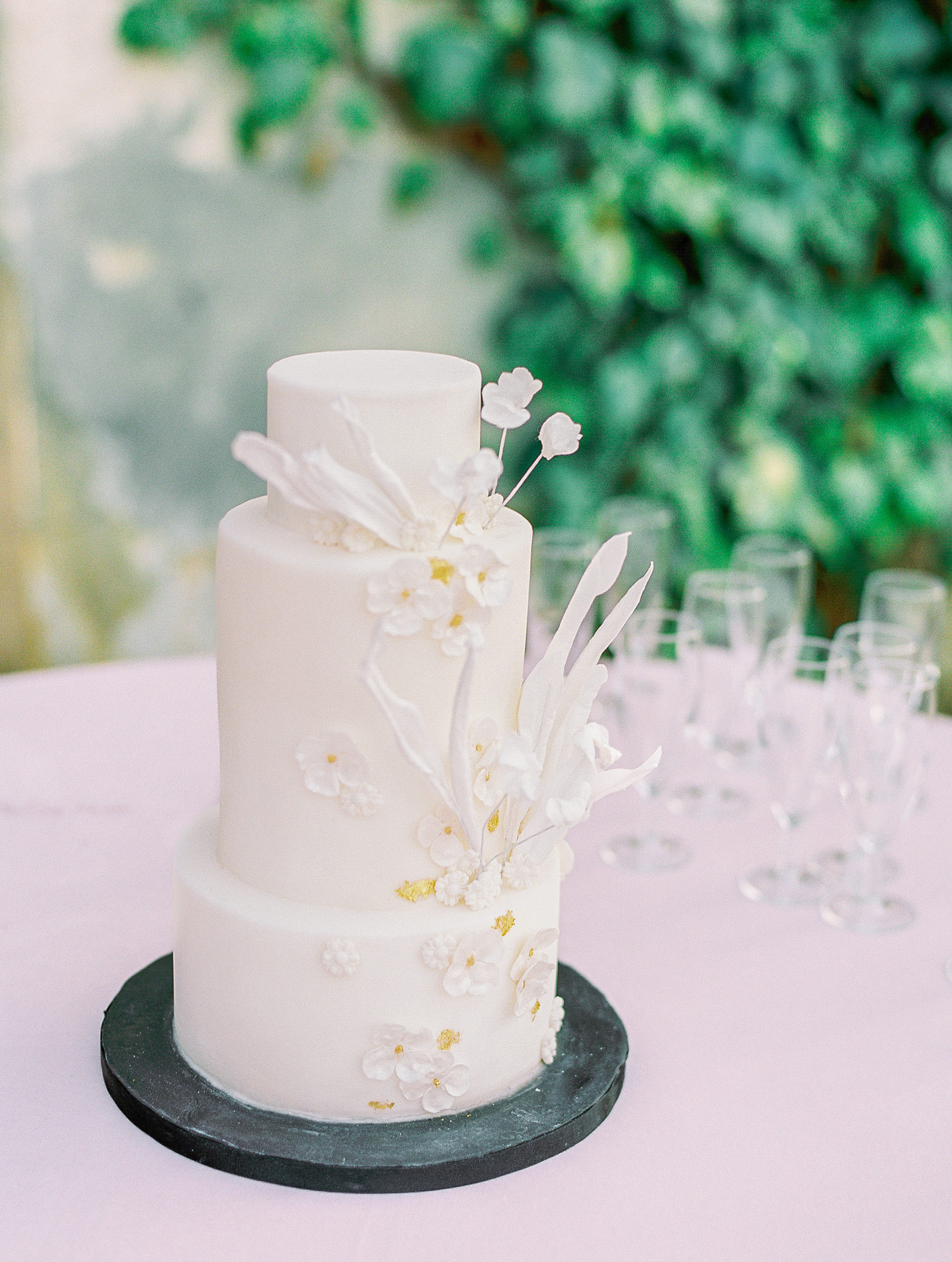 Simple cream wedding cake with white flowers at Chateau de Villette Wedding Photography