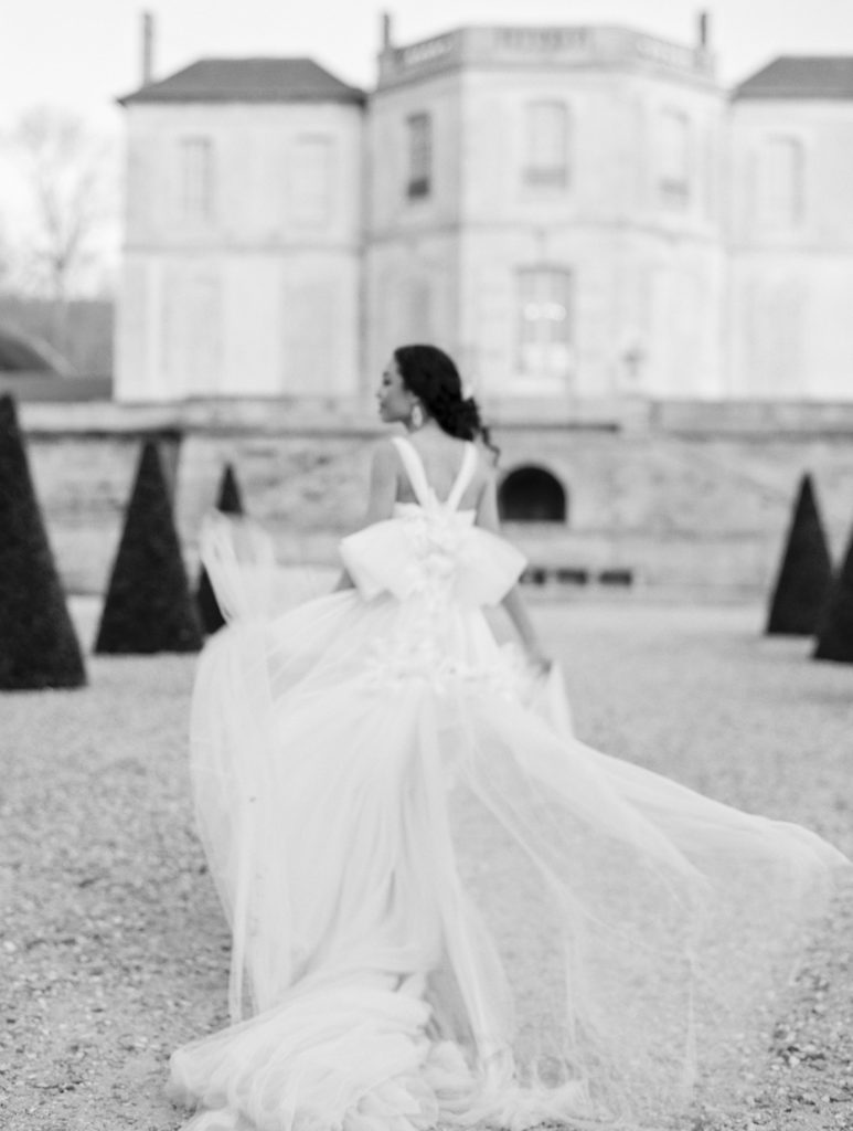 Bride walks away on the lawn in black and white at Chateau de Villette Wedding Photography