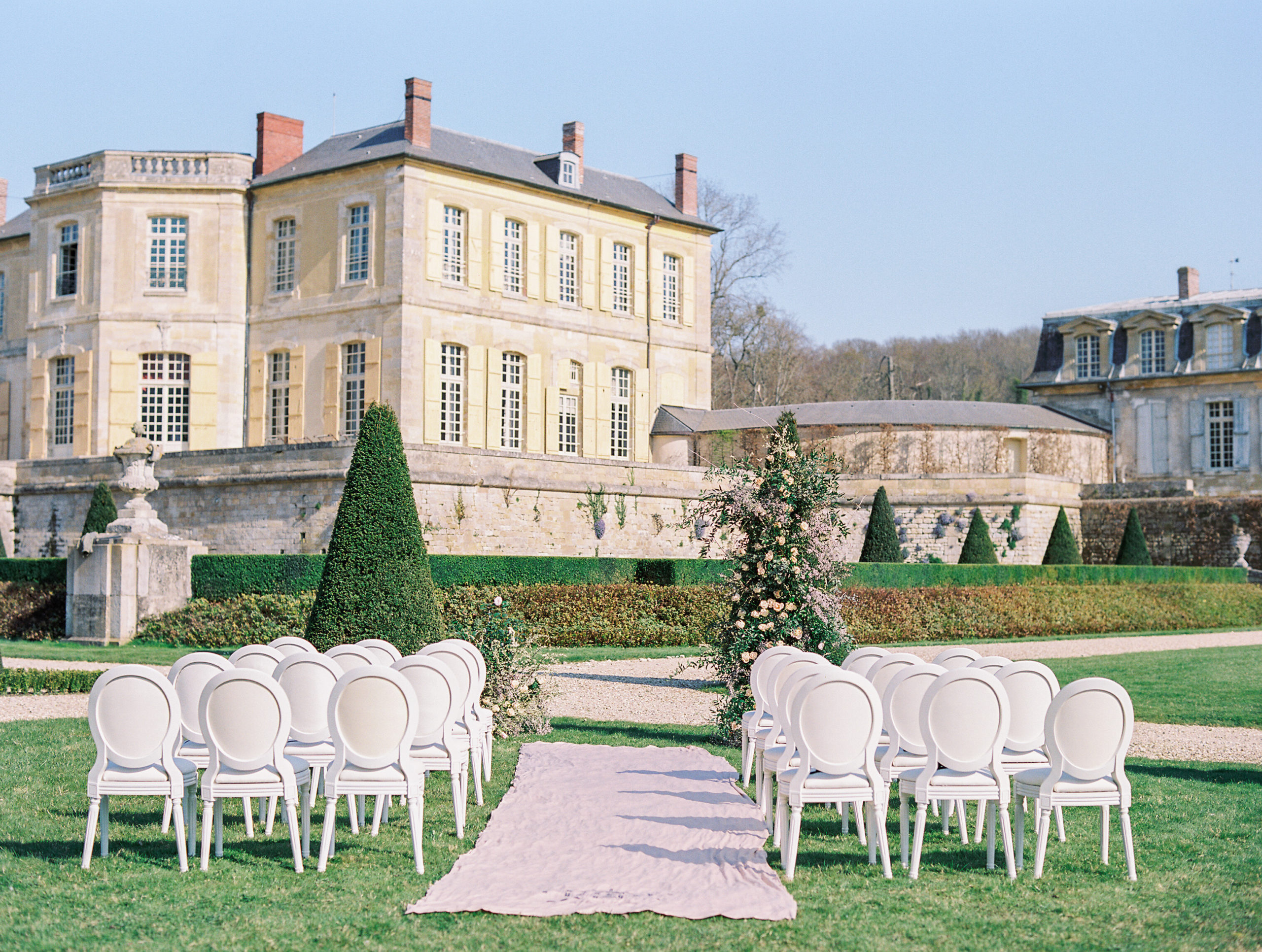White wedding chairs on lawn at Chateau de Villette Wedding Photography
