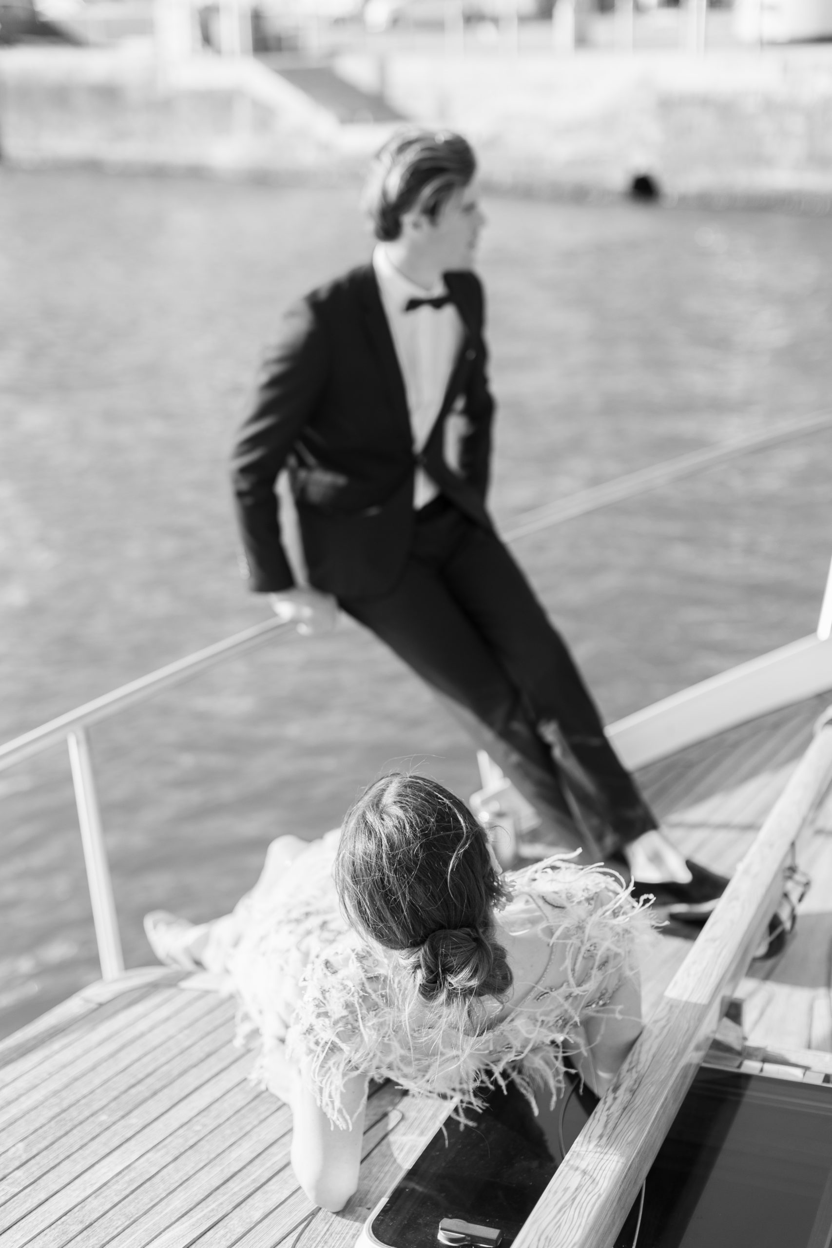 Couple overlooking the river on a boat for Sunset Paris Engagement 