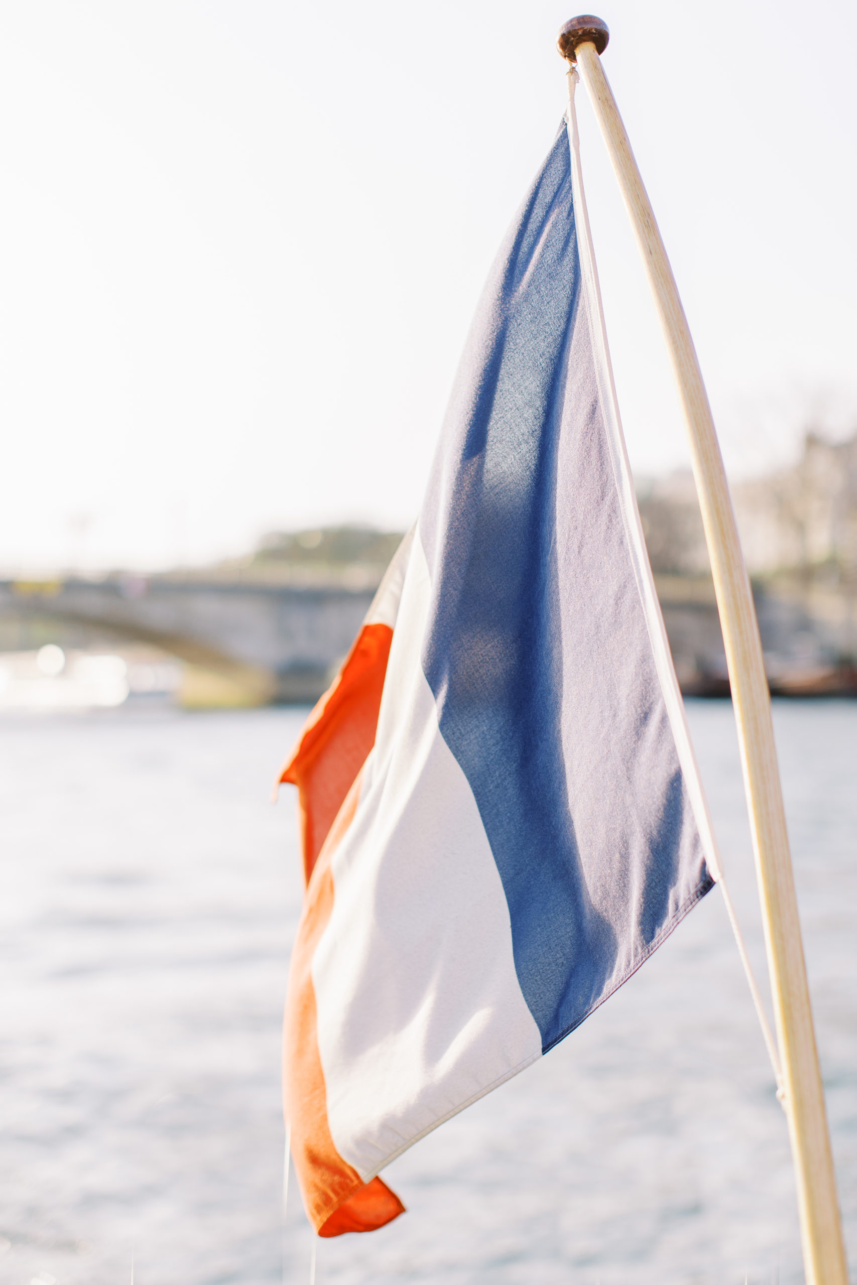 The French flag on a boat down the river in paris for Sunset Paris Engagement 