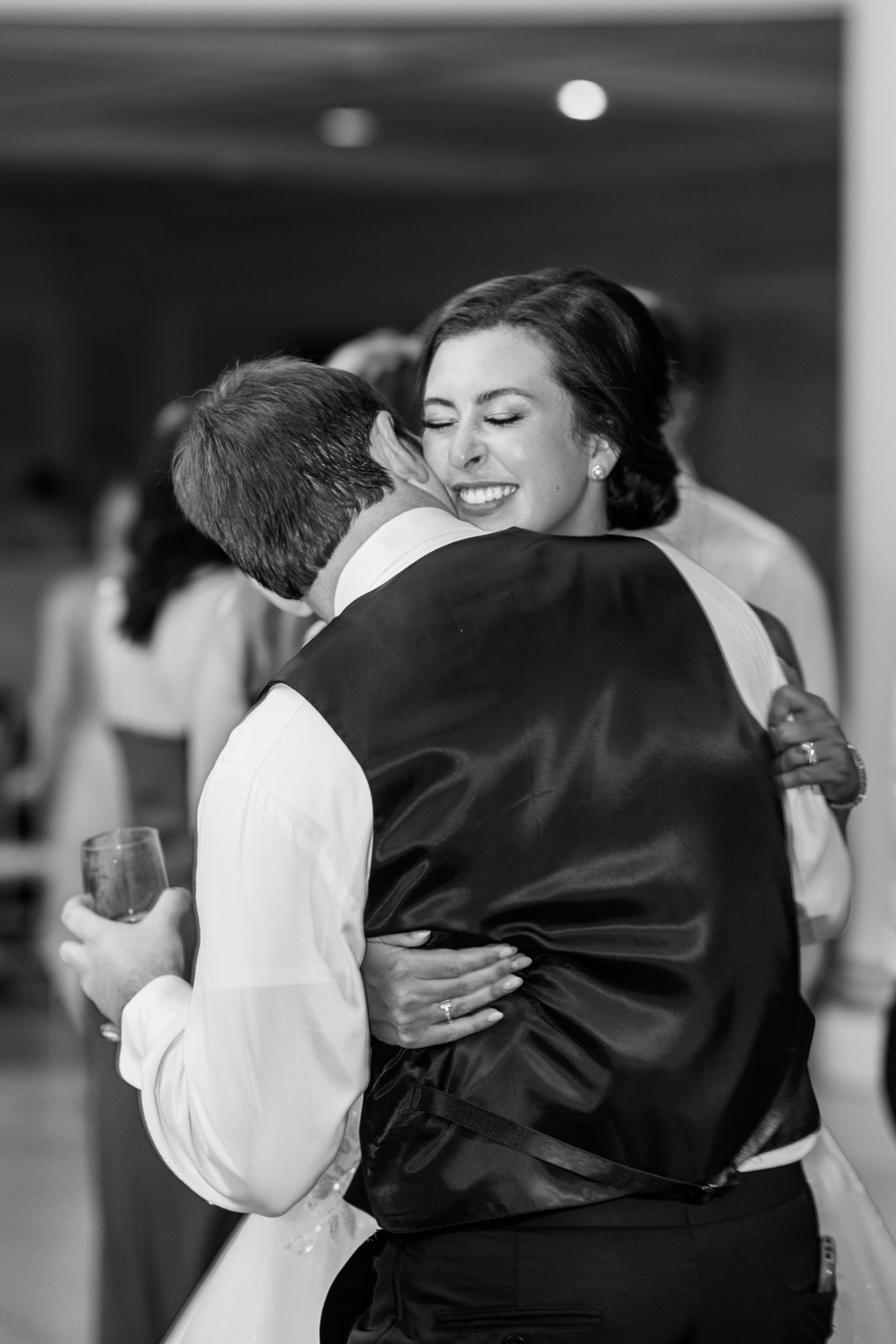 Bride and groom hug each other at wedding reception 