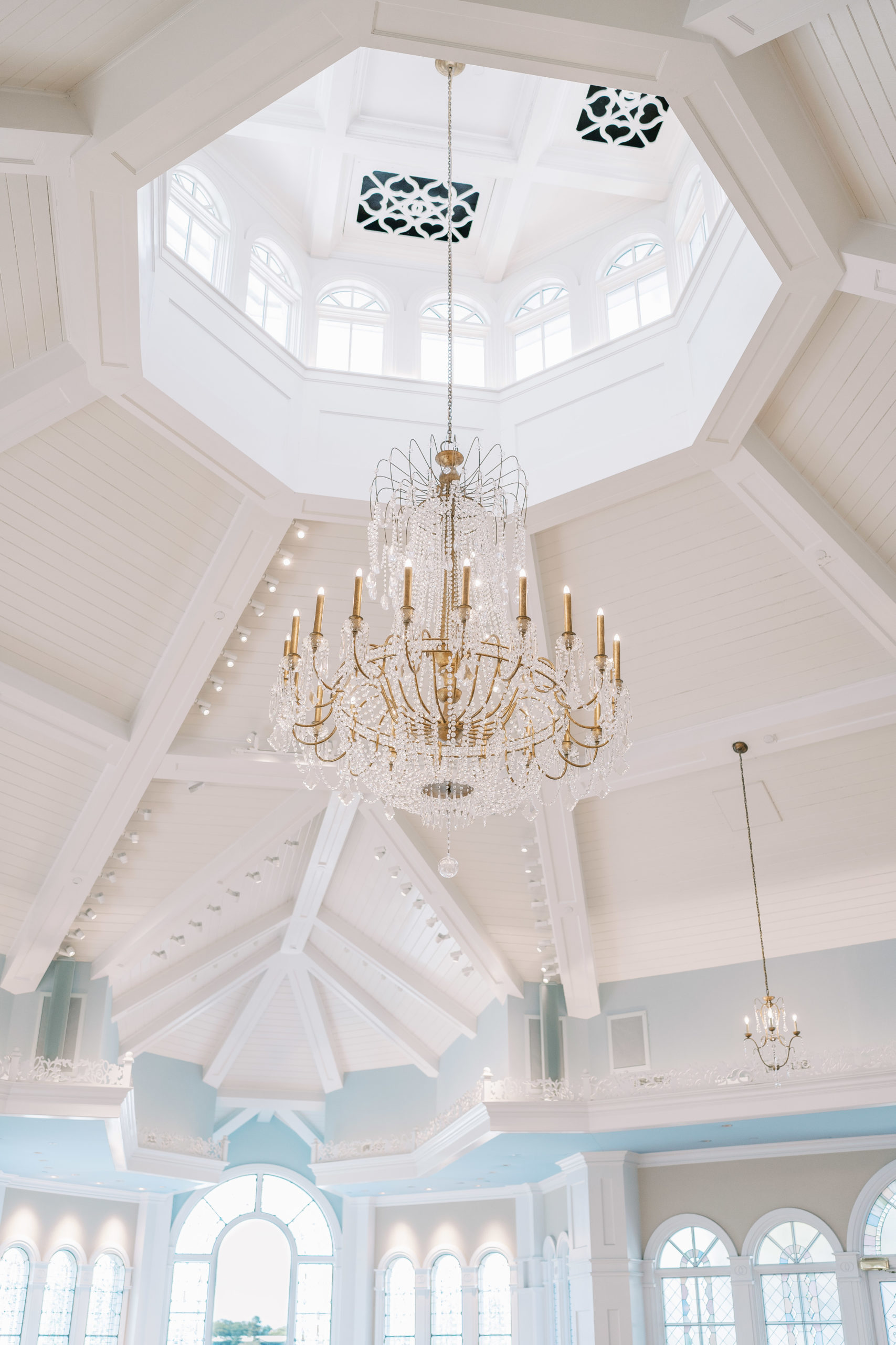 White and light blue wedding pavilion with golden and crystal chandelier 