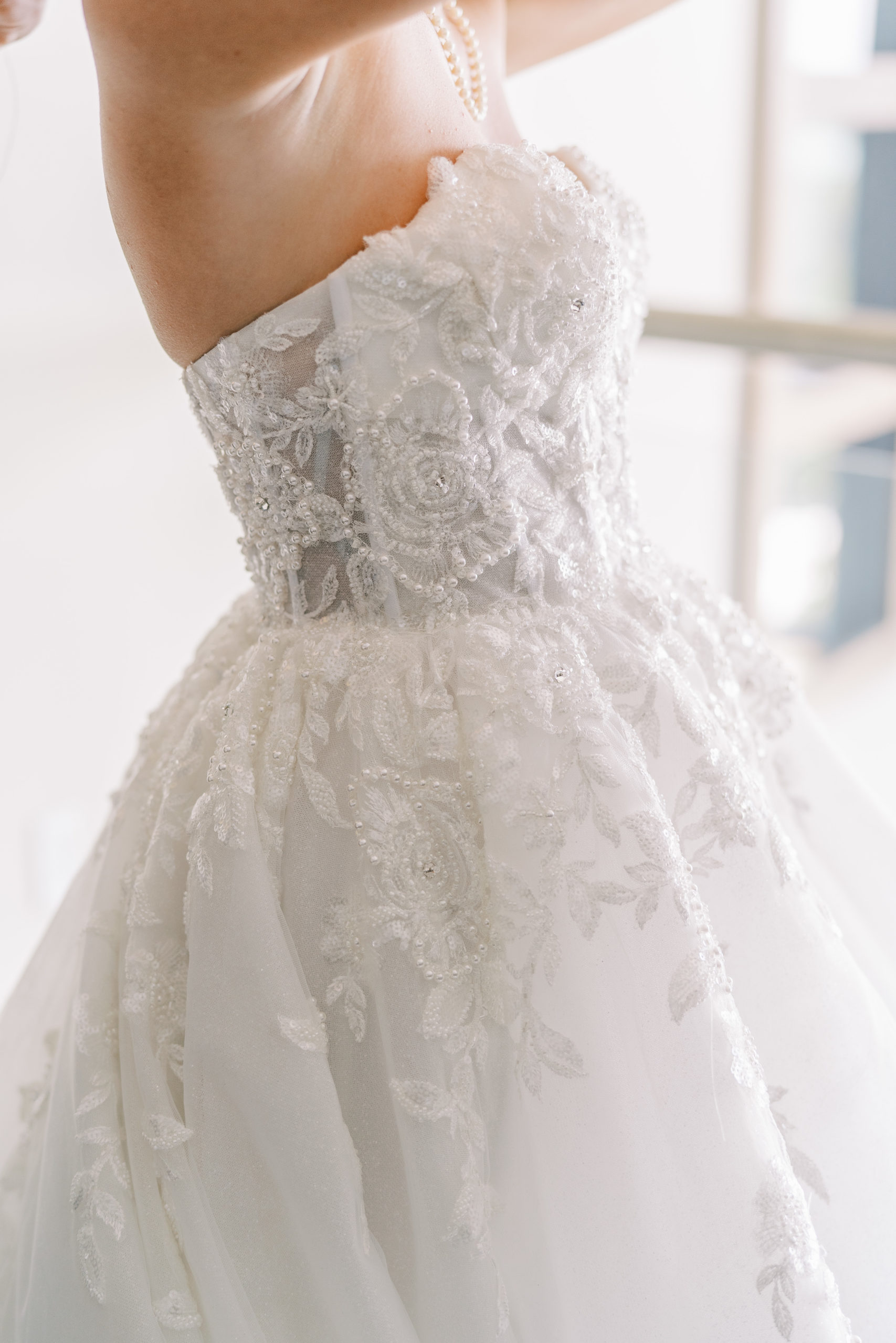 Side view of elegant floral embellished wedding dress 